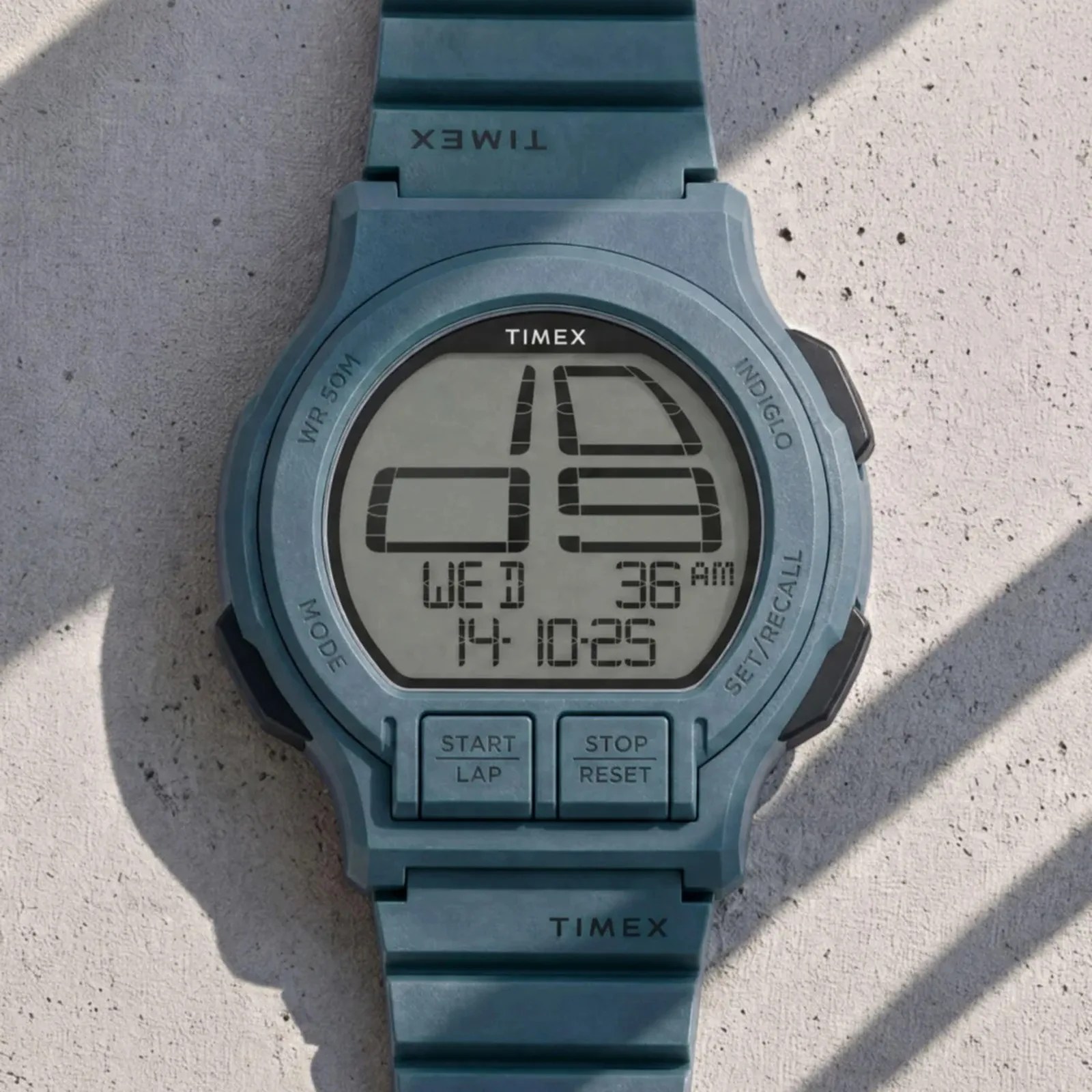 Blue Timex digital wristwatch with large segmented display and buttons labeled "Start Lap" and "Stop Reset.