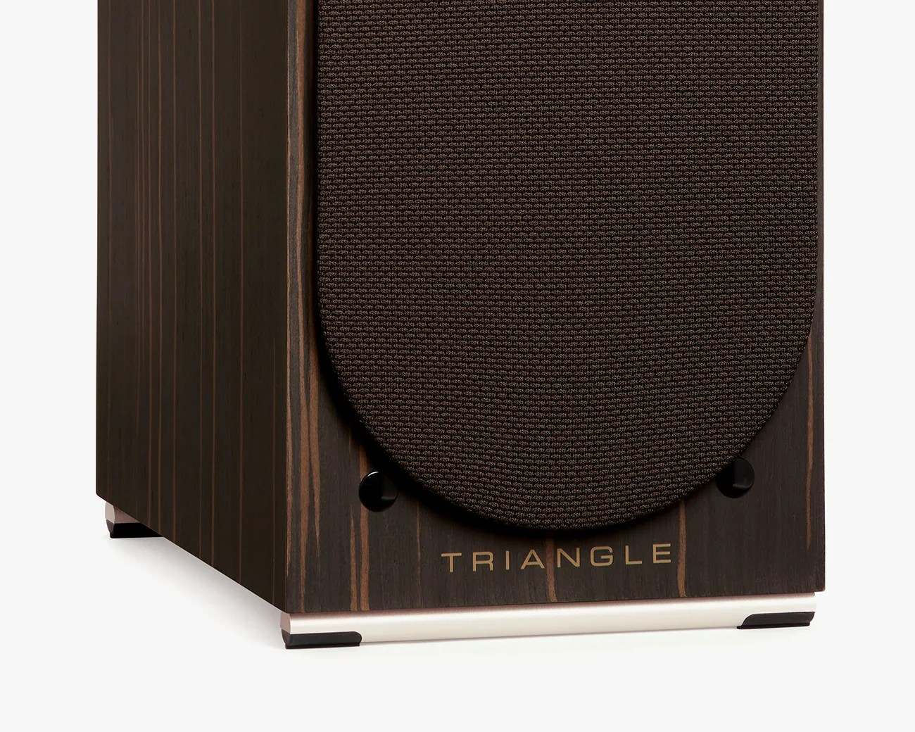 Close-up of the bottom front corner of a dark wood speaker with a brown fabric grille and the word "TRIANGLE" in gold letters.