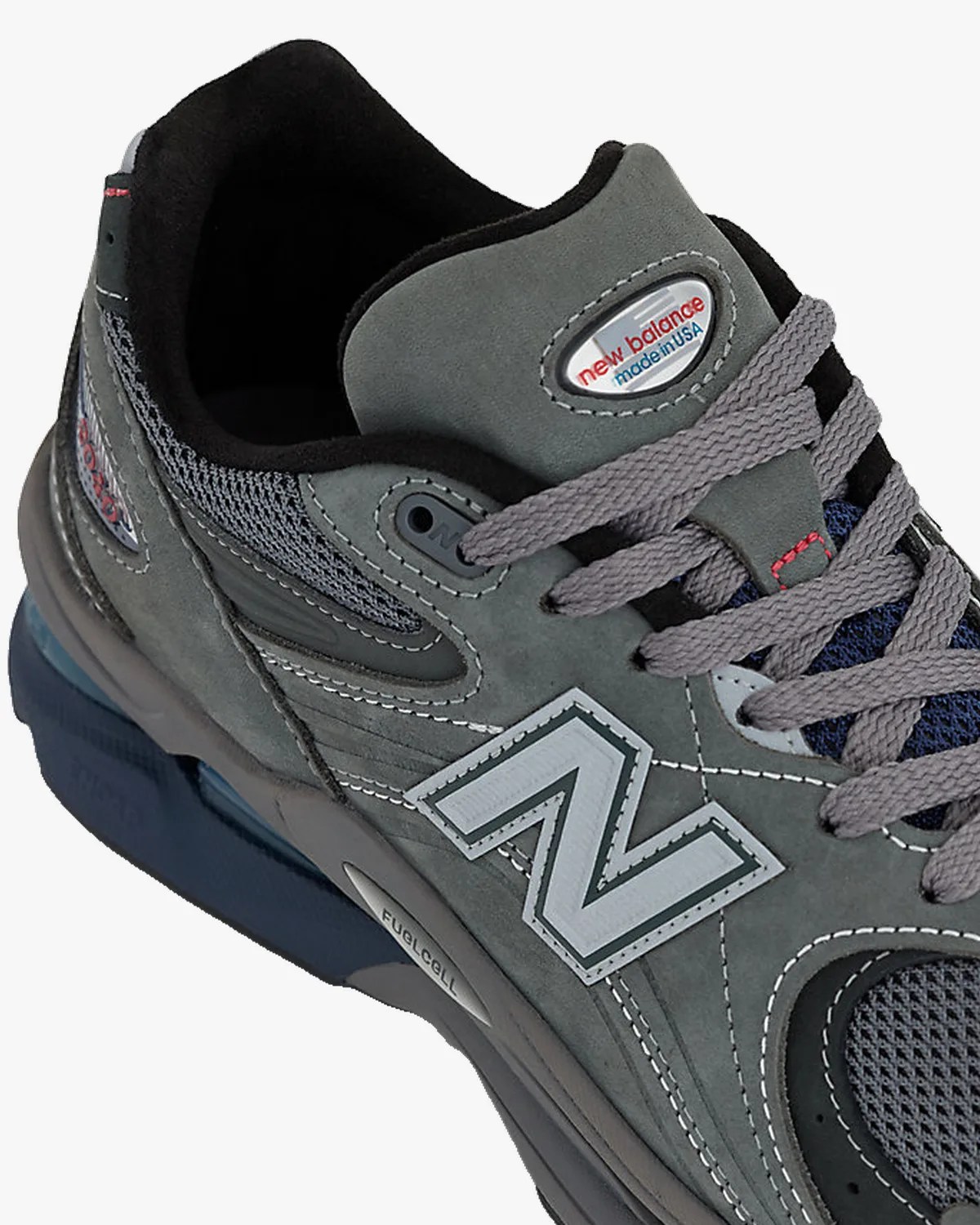 Gray New Balance sneaker with gray laces, mesh panels, and "FuelCell" label on the sole.