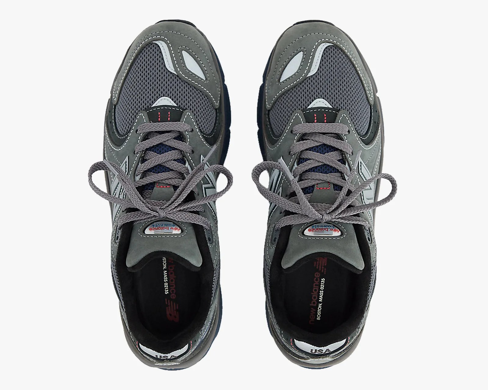 Pair of gray New Balance sneakers with mesh panels and gray laces viewed from above.