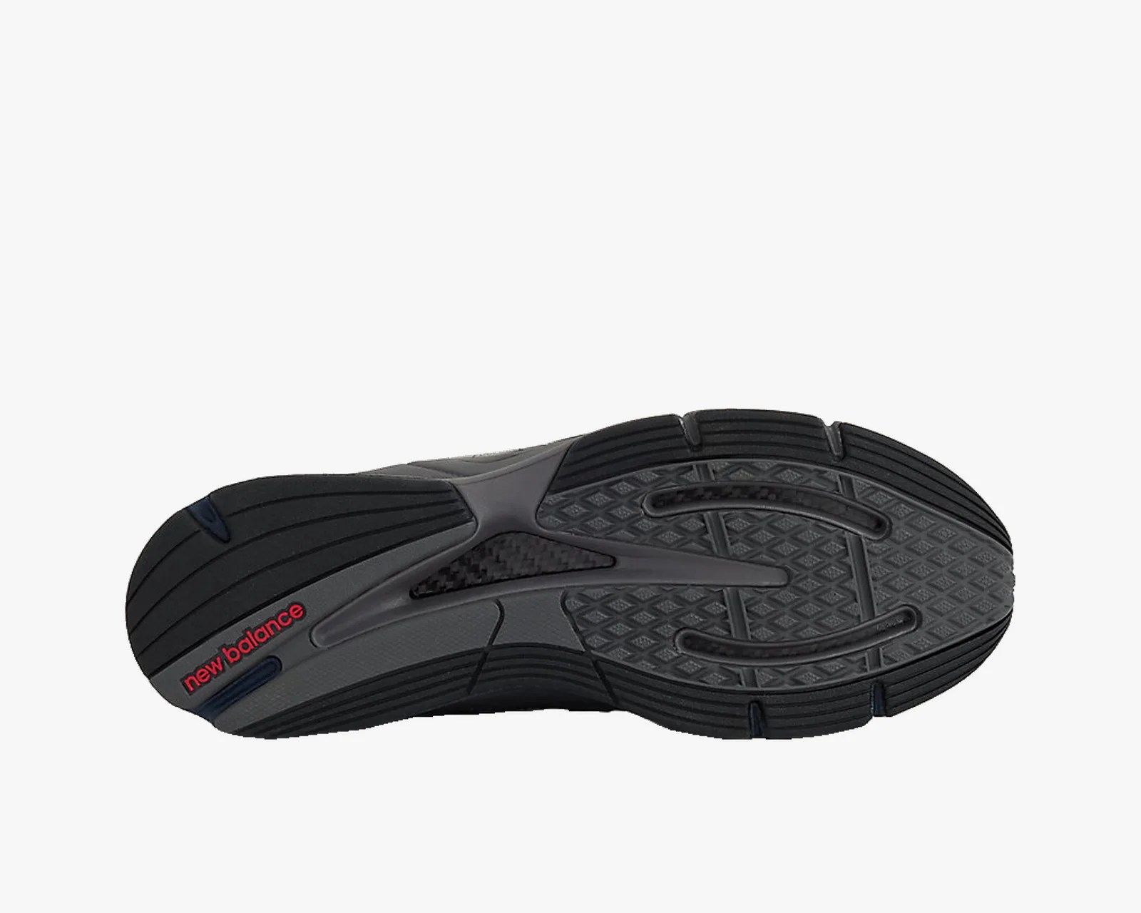 Black and gray New Balance shoe sole with textured grip and red logo near the heel.