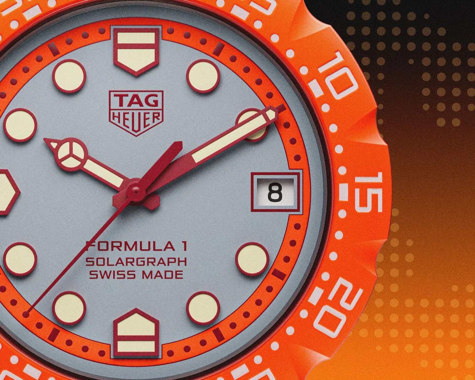 Close-up of a TAG Heuer Formula 1 Solargraph watch face with orange bezel and date window showing the number 8.
