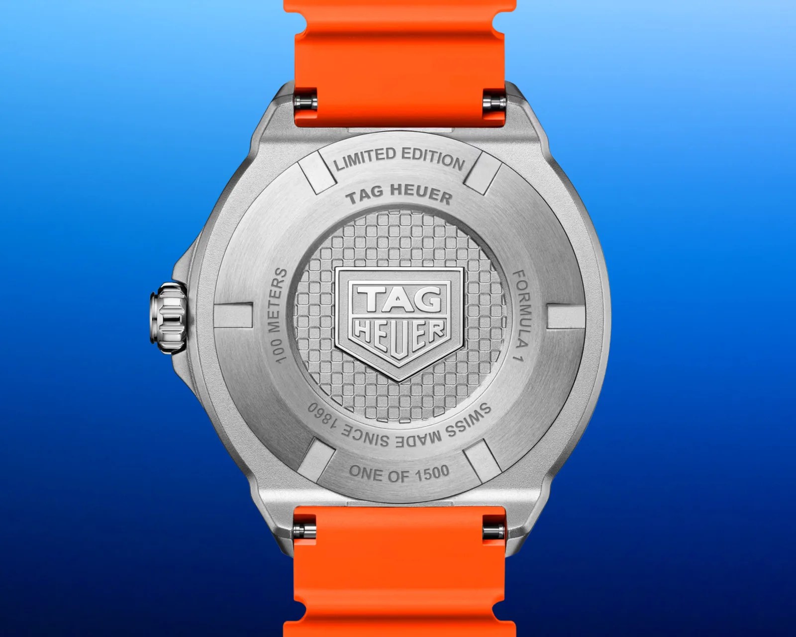 Back of a silver TAG Heuer Formula 1 watch with orange strap, engraved with "Limited Edition" and "One of 1500".
