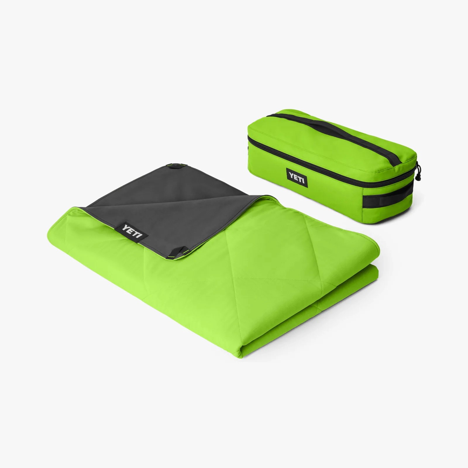Bright green and dark gray folded blanket with matching green zippered carrying case labeled YETI.