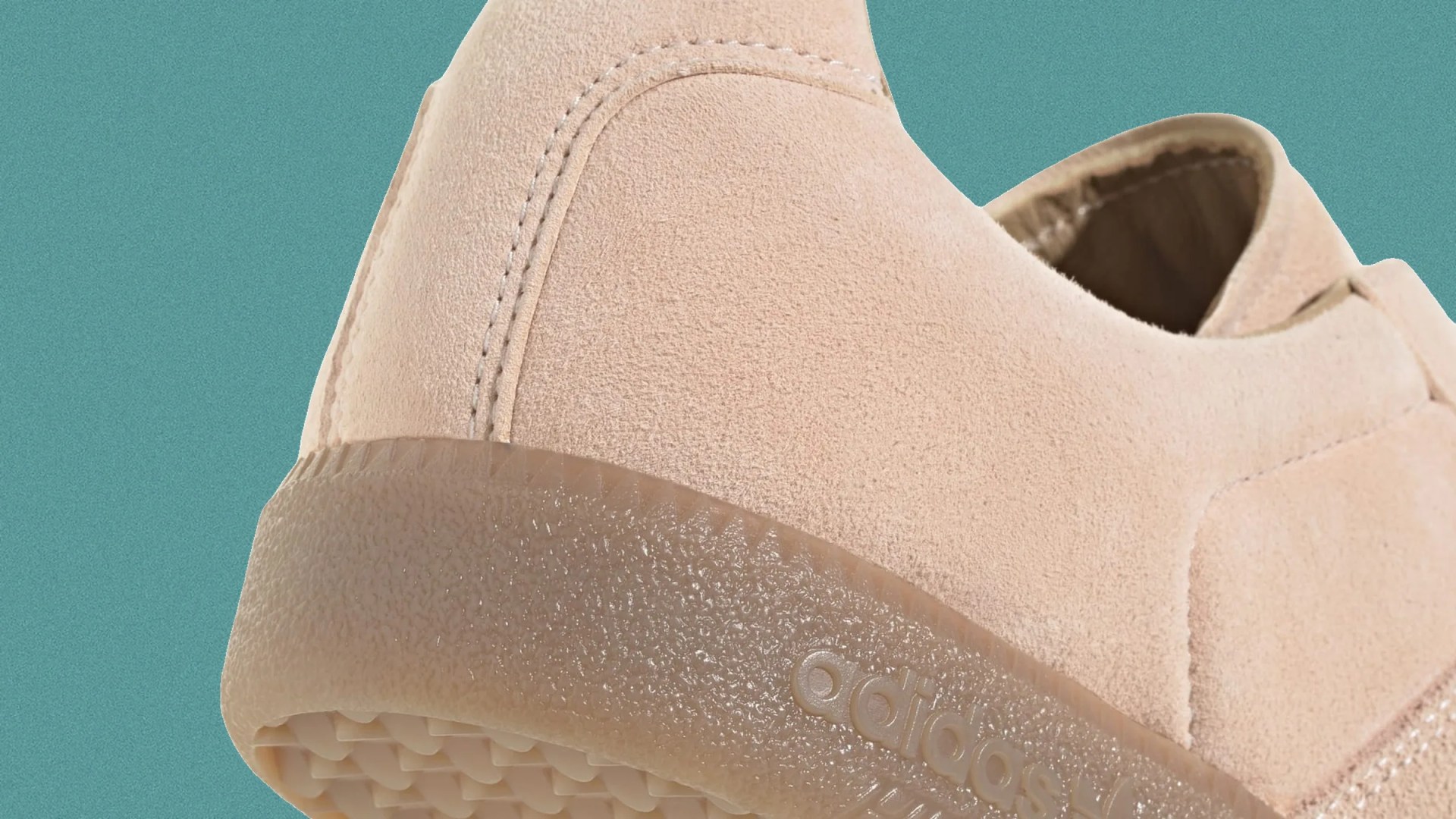 Close-up of a beige suede Adidas shoe heel with a textured translucent sole against a teal background.