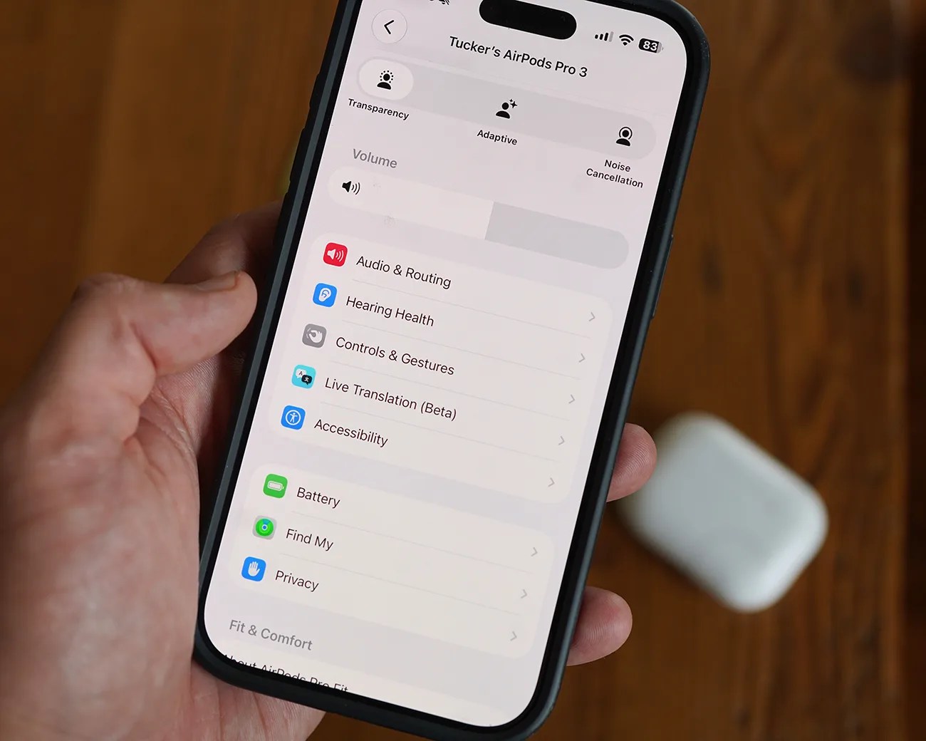 Smartphone screen showing settings for Tucker's AirPods Pro 3 with options like Transparency, Adaptive, Noise Cancellation, and menu items including Audio & Routing, Hearing Health, Controls & Gestures.
