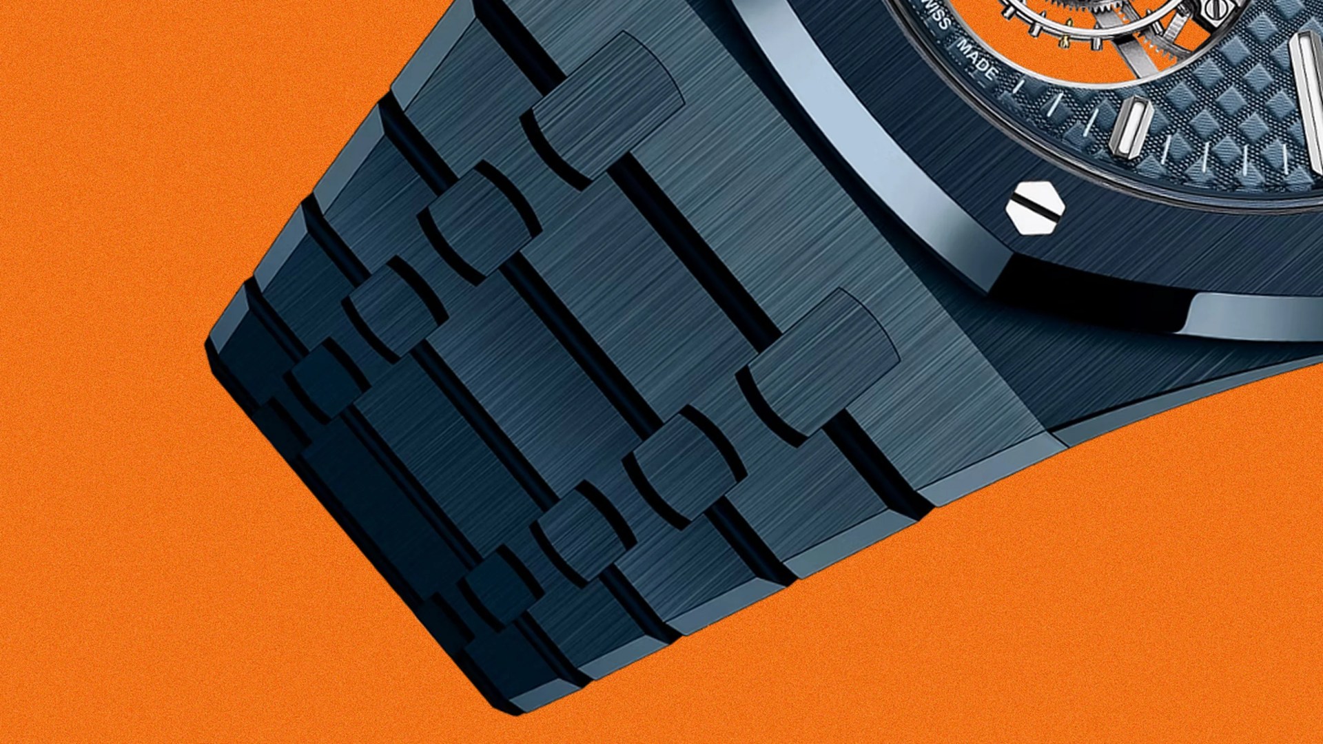 Close-up of a dark blue brushed metal watch band with a textured watch face on an orange background.