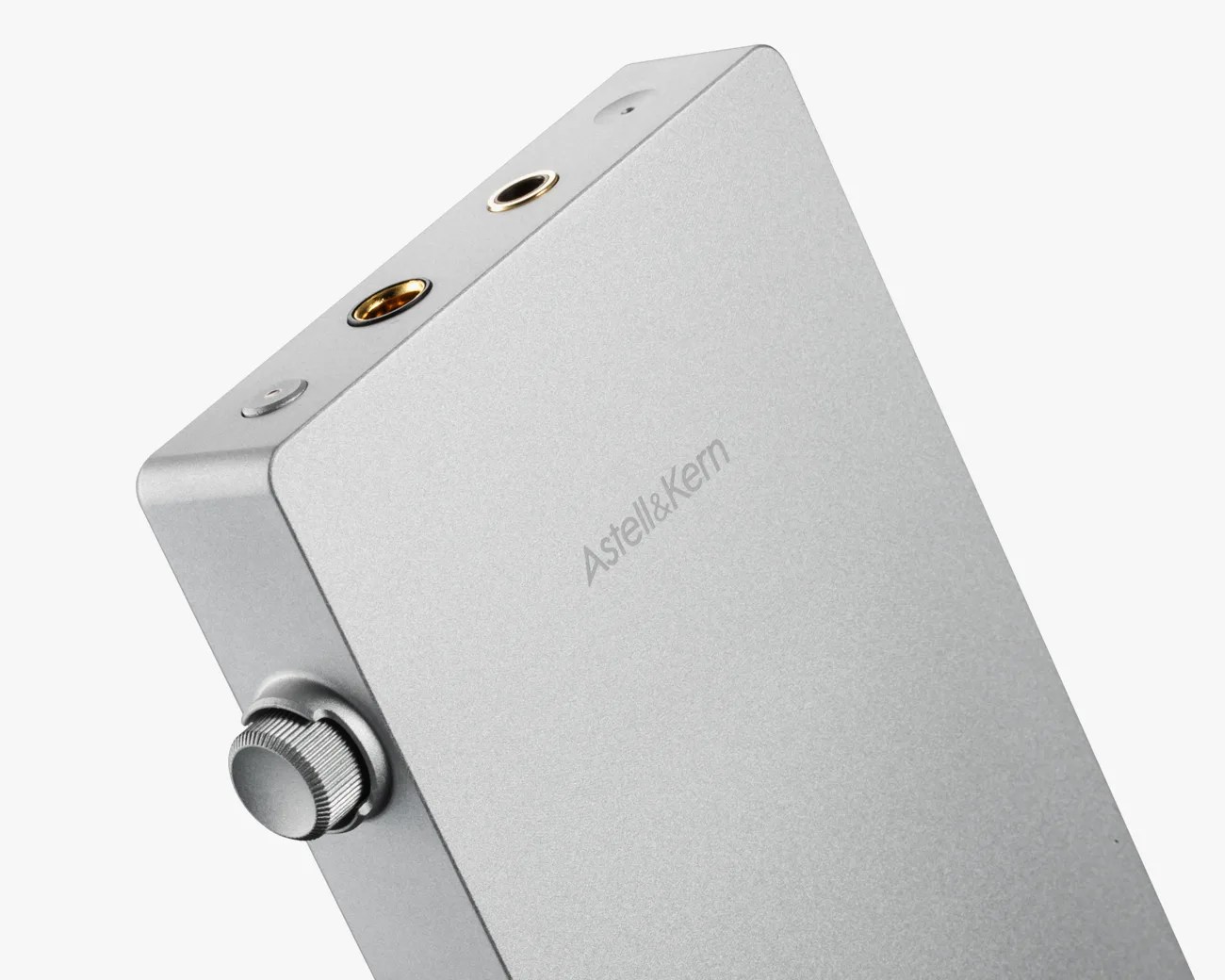 Silver rectangular Astell&Kern audio device with a volume knob and two headphone jacks on top.