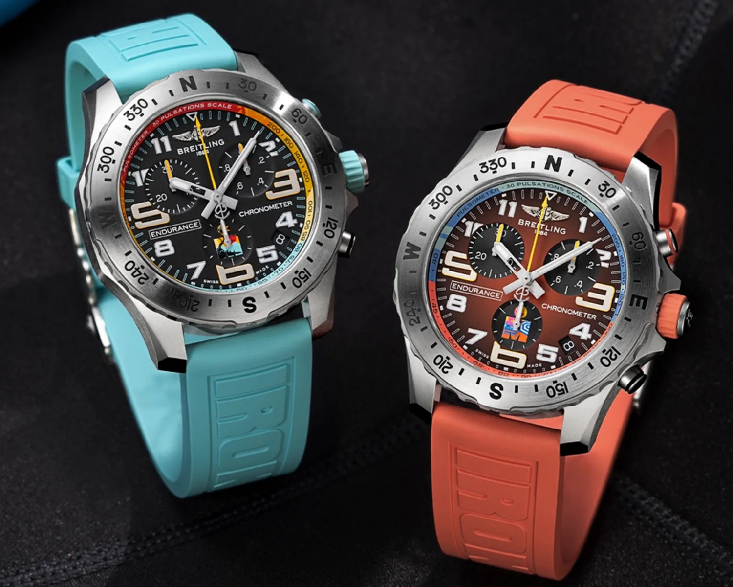 Two Breitling Endurance chronometer watches with stainless steel cases, one with a turquoise rubber strap and black dial, the other with an orange rubber strap and brown dial.