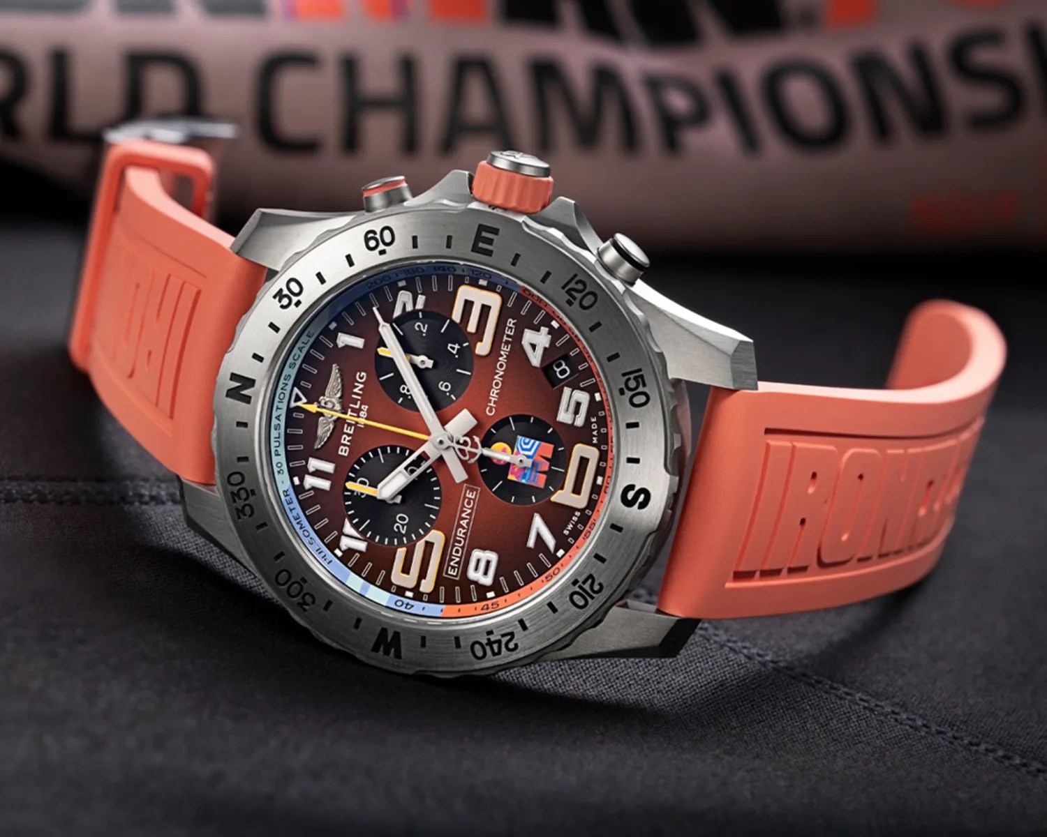 Breitling Endurance chronometer watch with orange rubber strap and brown dial with black subdials.