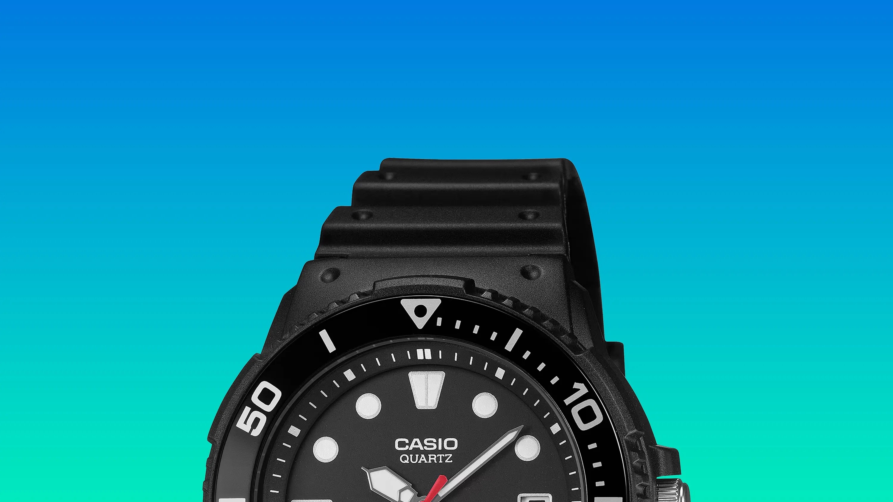 Black Casio Quartz watch with white markers and a black resin strap against a blue gradient background.