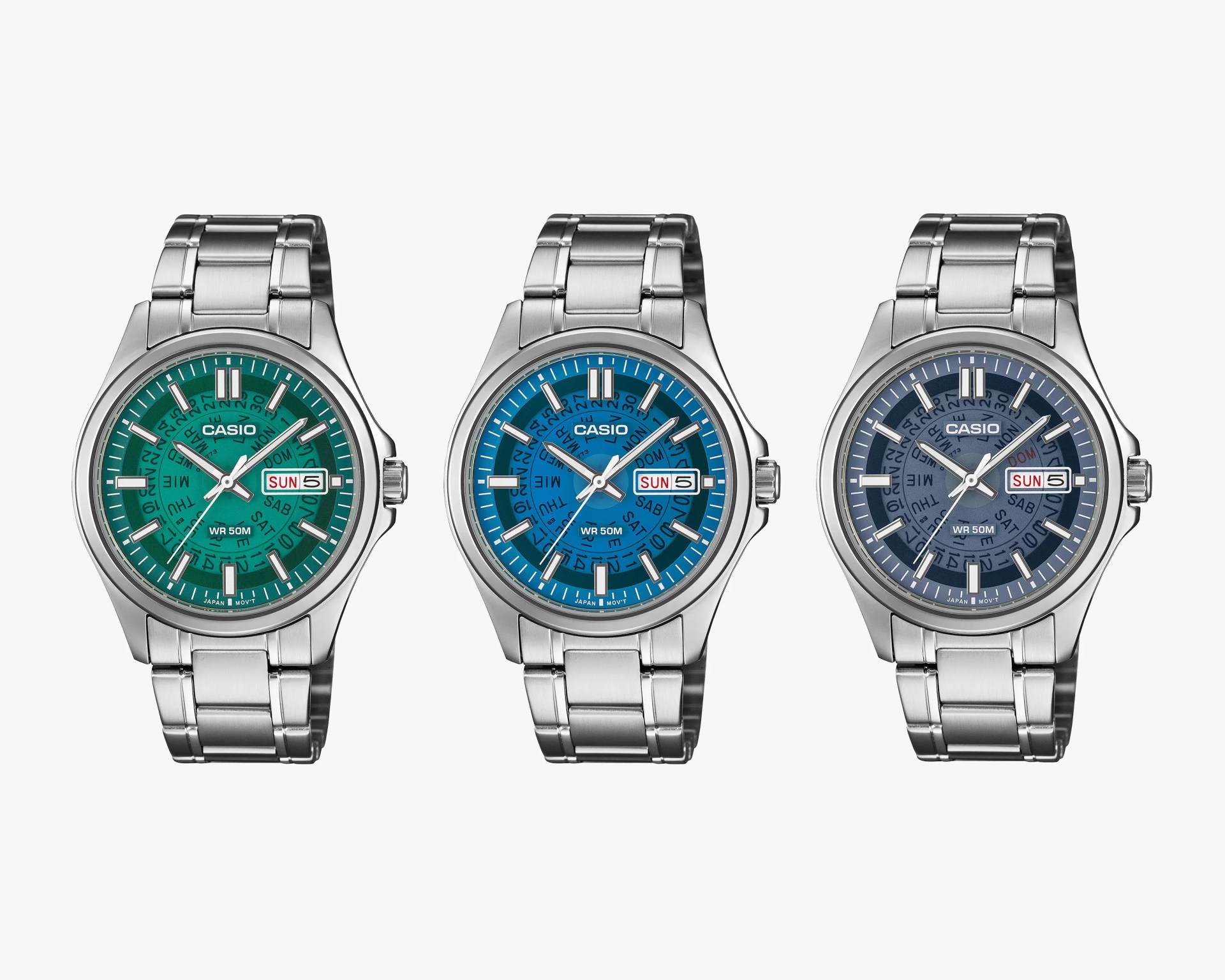 Three Casio wristwatches with stainless steel bands and green, blue, and dark blue dials showing day and date.