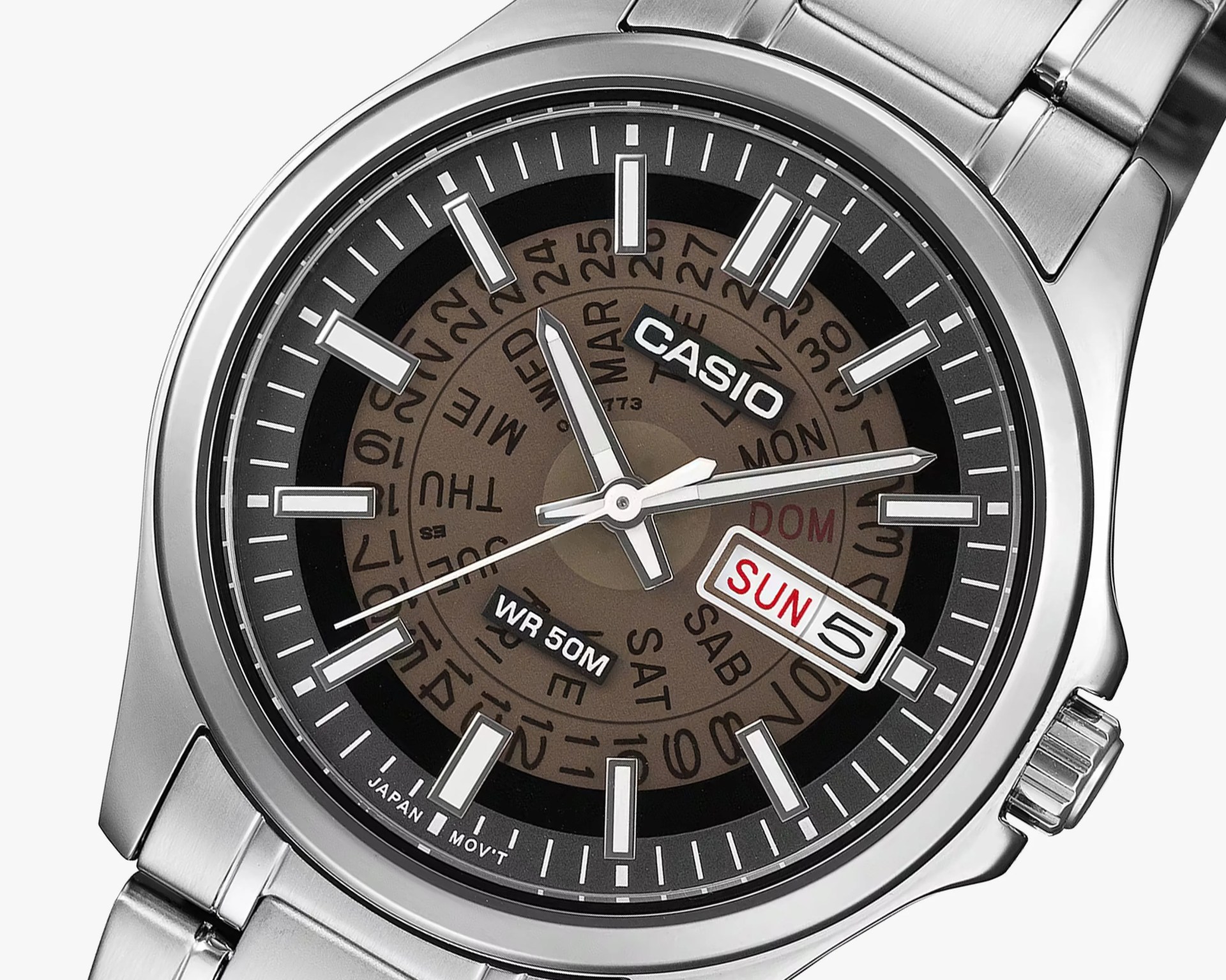 Close-up of a Casio wristwatch with a silver metal band, black and brown dial, and day-date display showing Sunday the 5th.