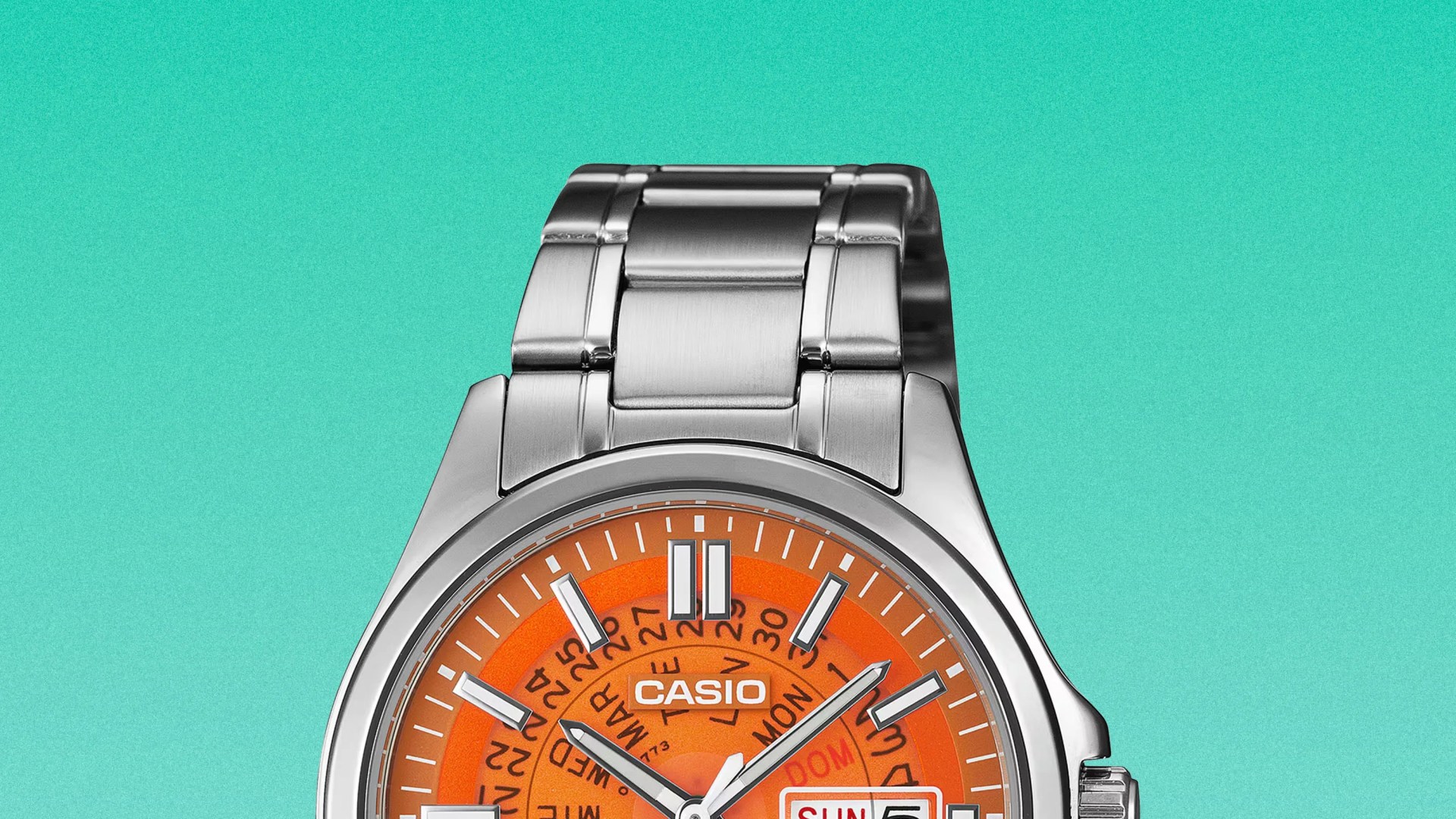 Silver metal Casio watch with an orange dial and day-date display on a turquoise background.