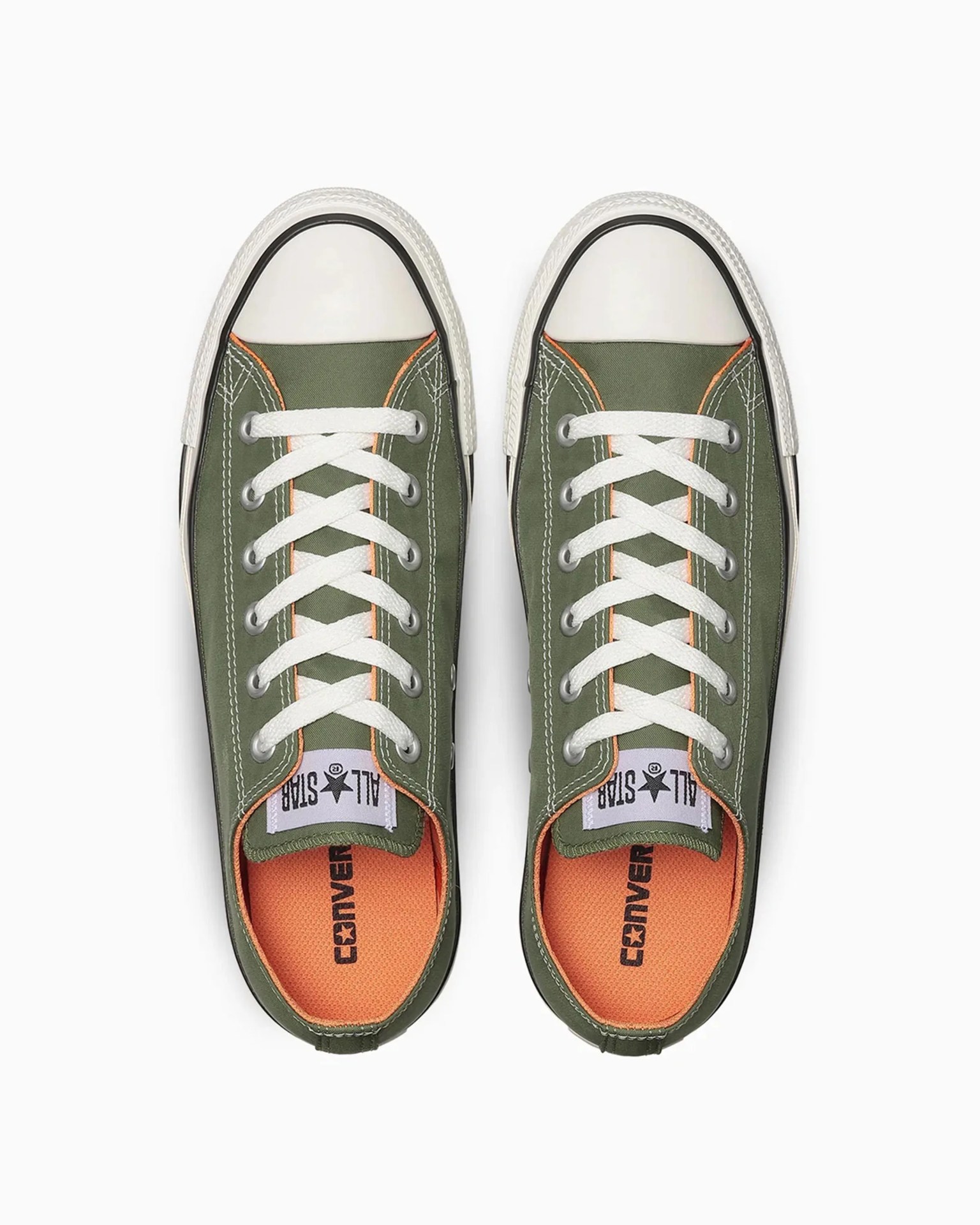 Pair of olive green Converse All Star sneakers with white laces and orange insoles viewed from above.