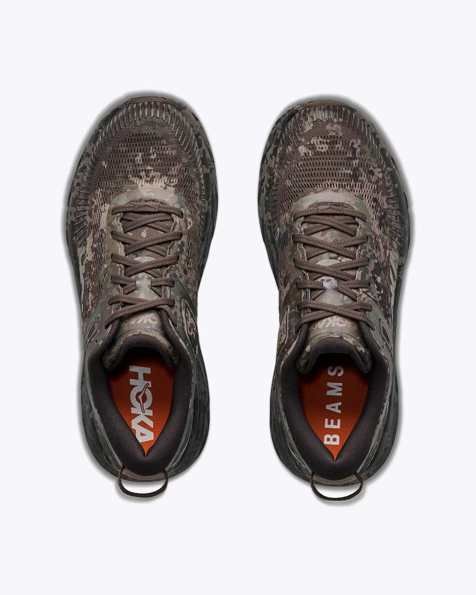 Pair of camo-patterned running shoes with brown laces and orange insoles, viewed from above.