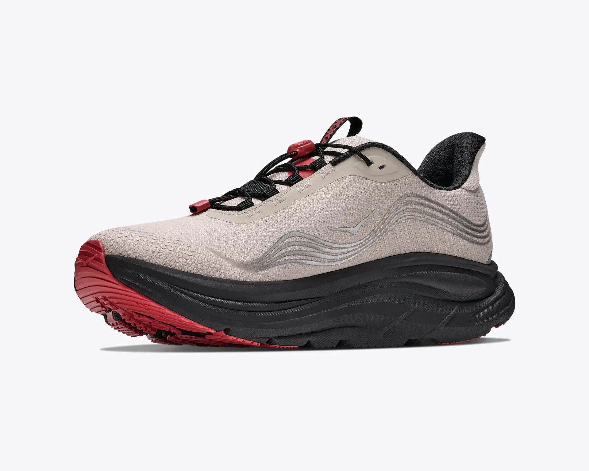 Beige and black running shoe with red accents and a thick black sole.