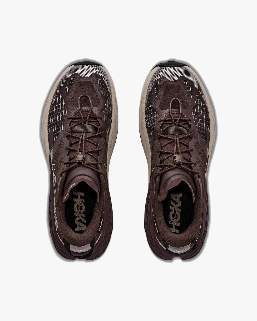 Pair of dark brown Hoka running shoes with beige midsoles and black insoles, viewed from above.
