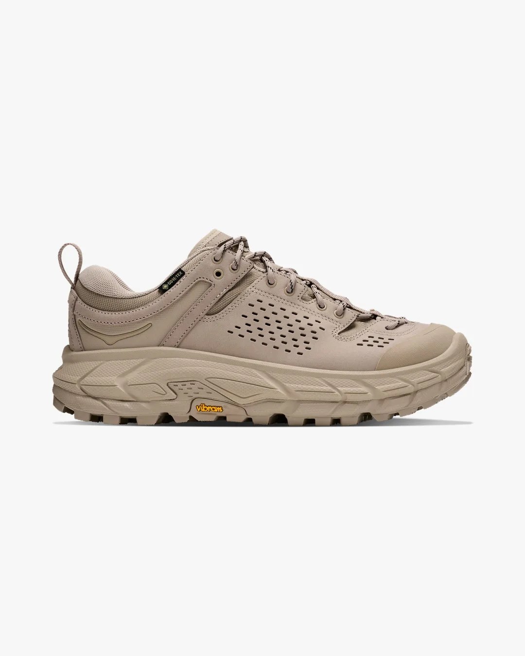 Beige low-top hiking shoe with perforated sides, lace-up closure, and Vibram sole.