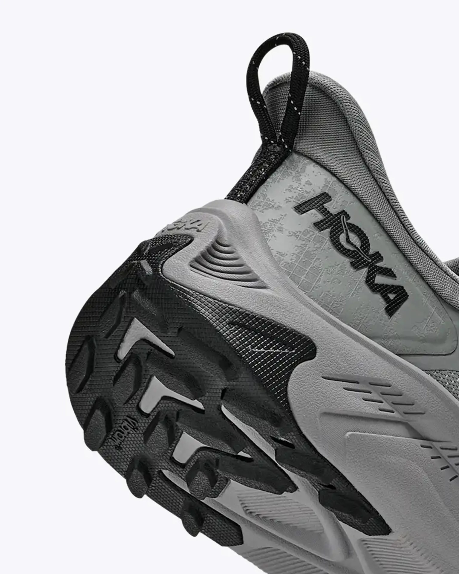 Gray and black Hoka sneaker with rugged Vibram sole and pull tab at heel.