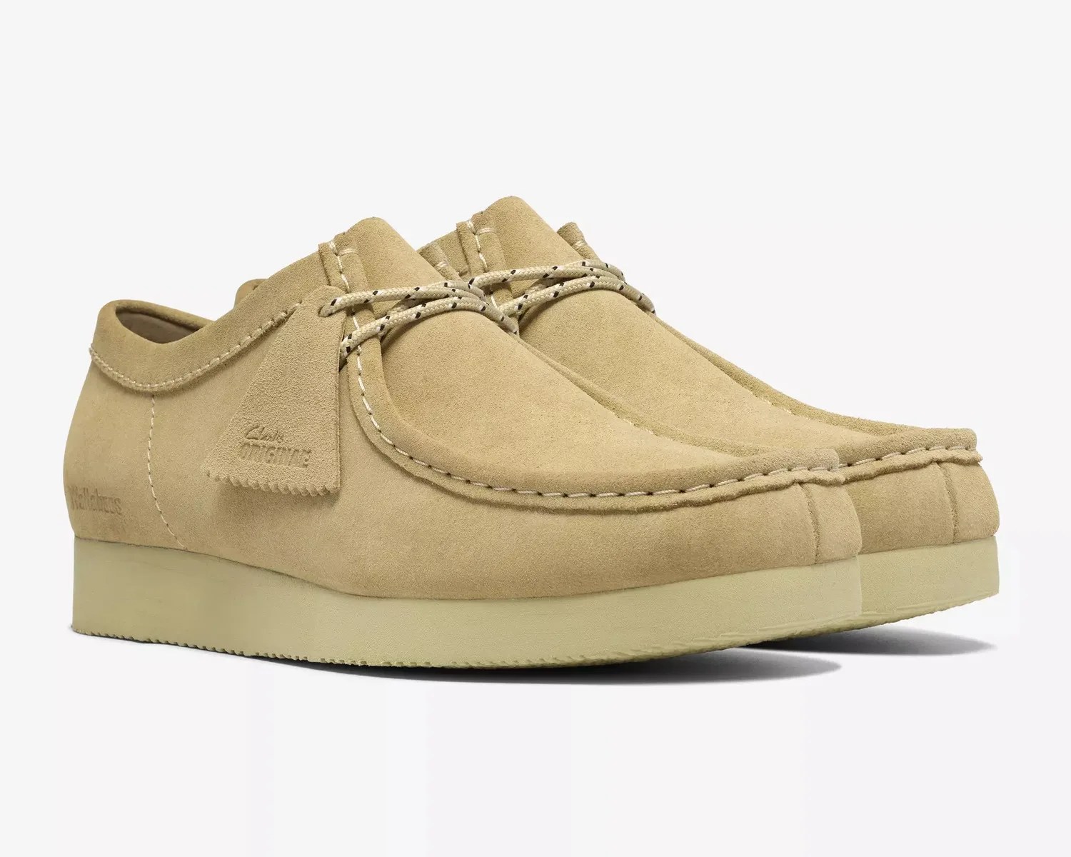 Pair of beige suede Clarks Wallabee shoes with crepe soles and moccasin-style stitching.