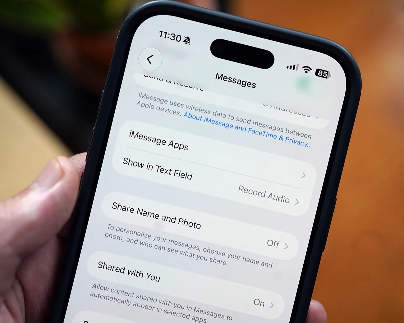 Smartphone screen showing iMessage settings with options for Show in Text Field, Share Name and Photo, and Shared with You.