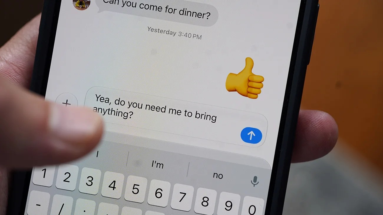 Close-up of a smartphone screen showing a text message conversation with the message "Yea, do you need me to bring anything?" being typed.
