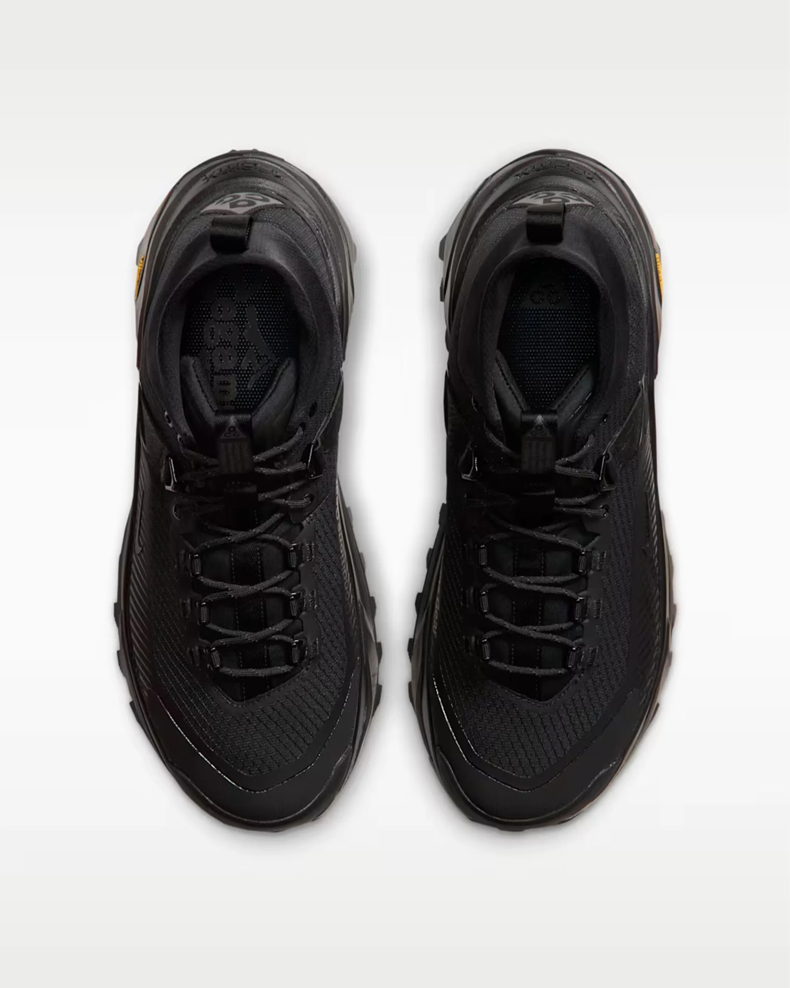 Pair of black trail running shoes with mesh uppers and black laces viewed from above.