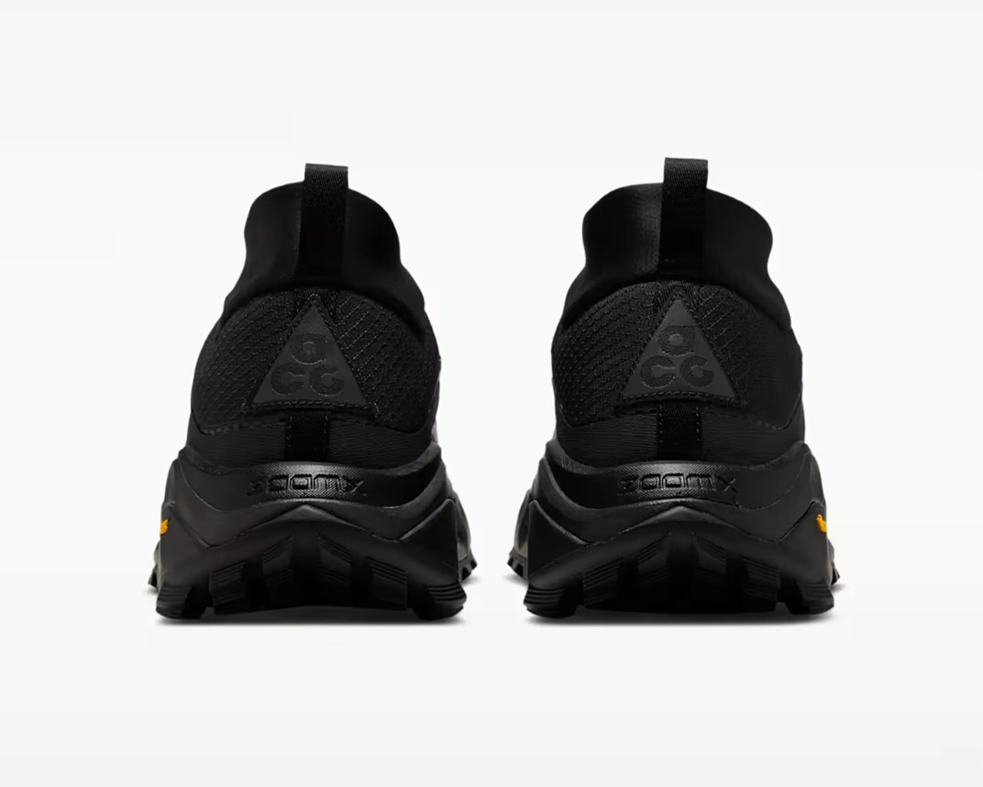 Pair of black athletic shoes with ACG logo on the heel and pull tabs at the back.