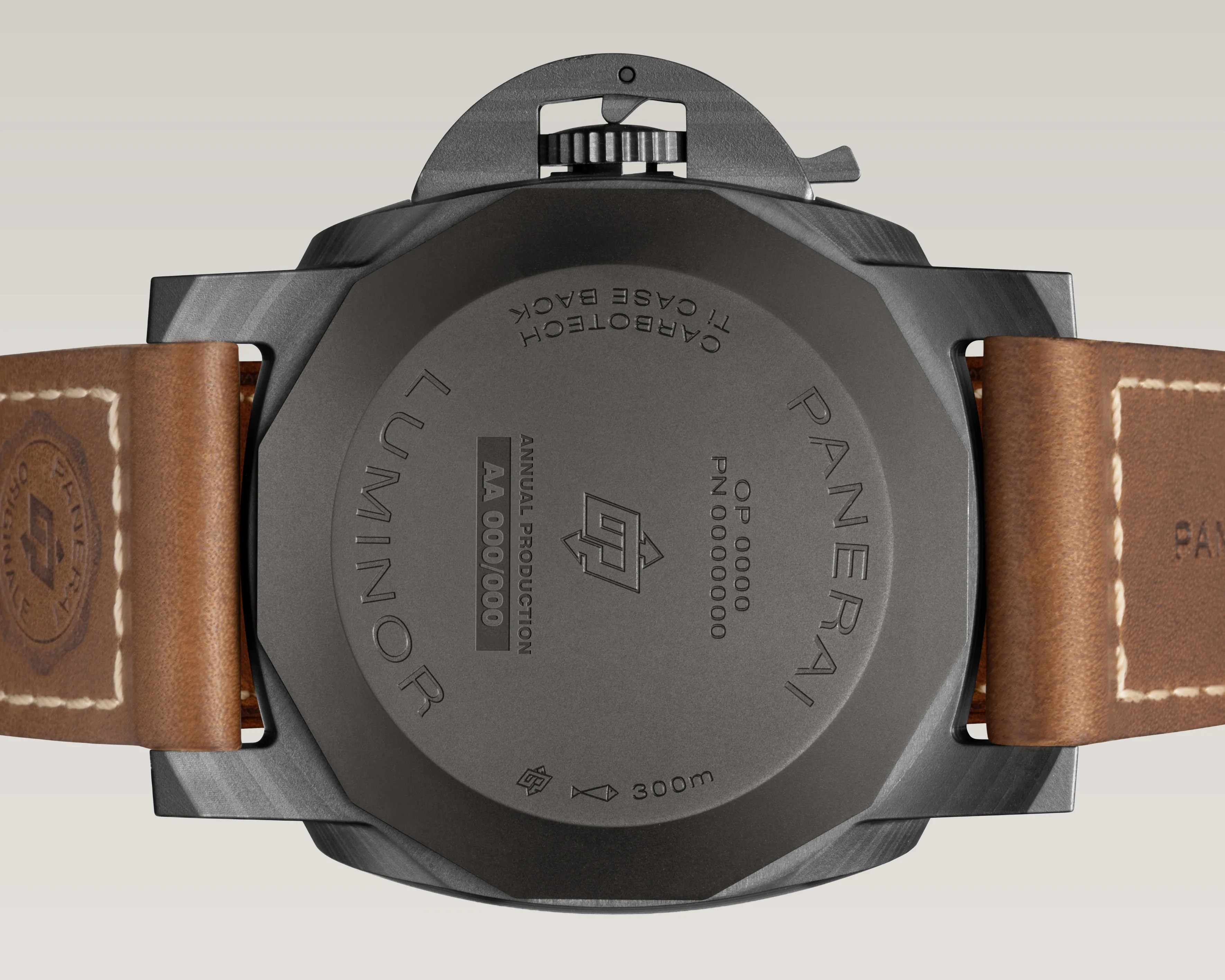 Back of a Panerai Luminor watch with a black case and brown leather strap showing engravings and a crown guard.