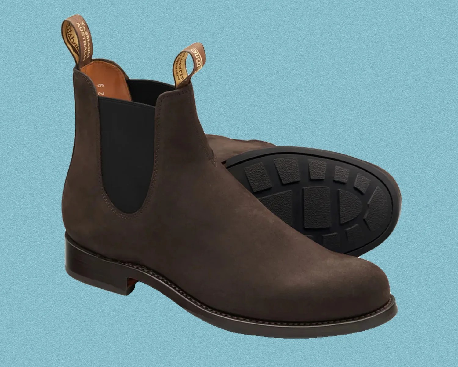 Pair of dark brown suede Chelsea boots with black elastic side panels and pull tabs.