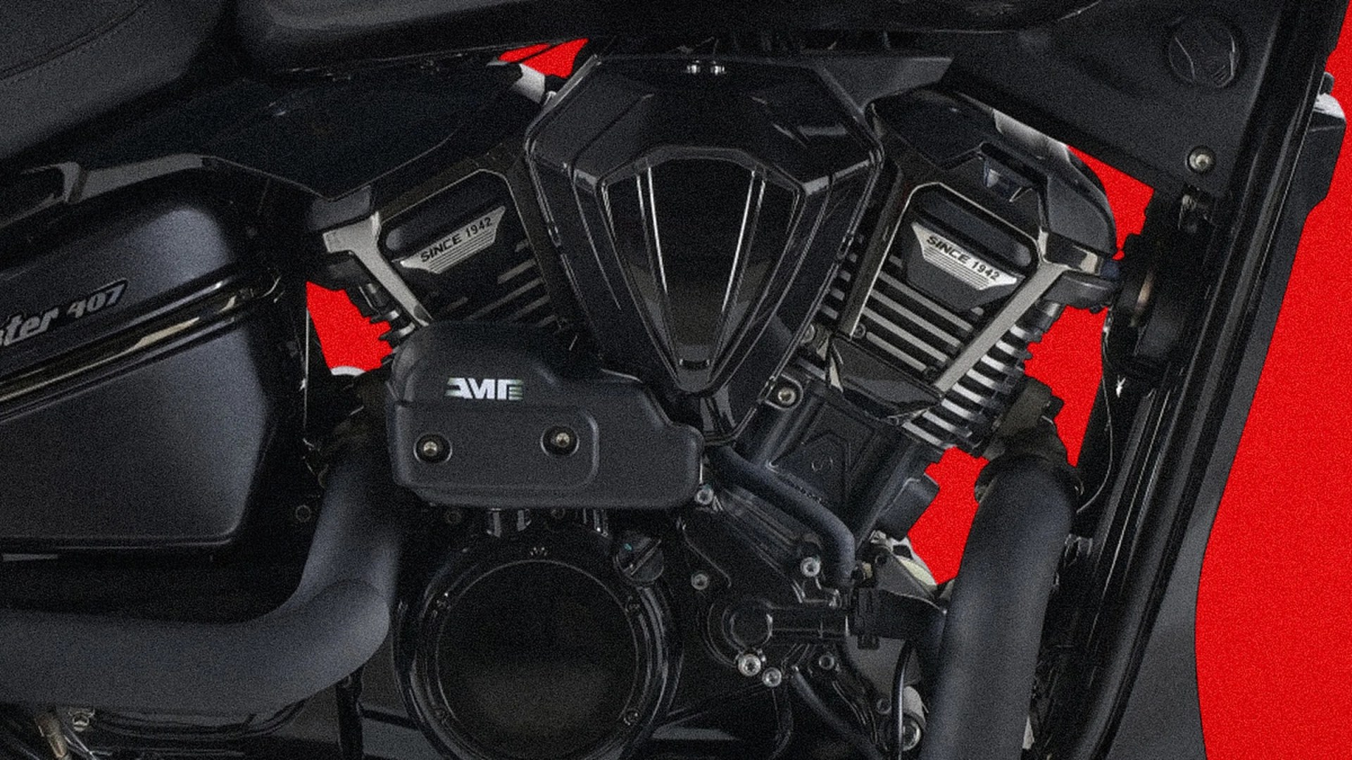 Close-up of a black motorcycle engine with "Since 1942" labels on the cylinders and "Interceptor 407" on the side cover.