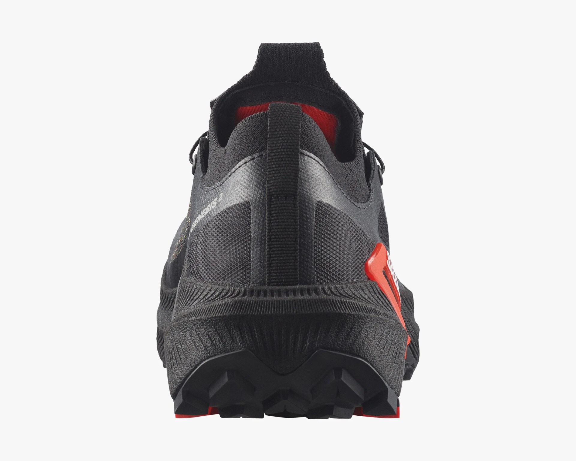Rear view of a black athletic shoe with textured sole and red interior lining.