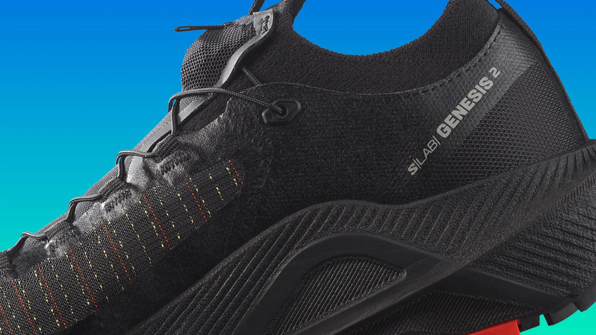 Black athletic shoe with knit upper, multicolor stitching, and "SILAB | GENESIS 2" text on the side.