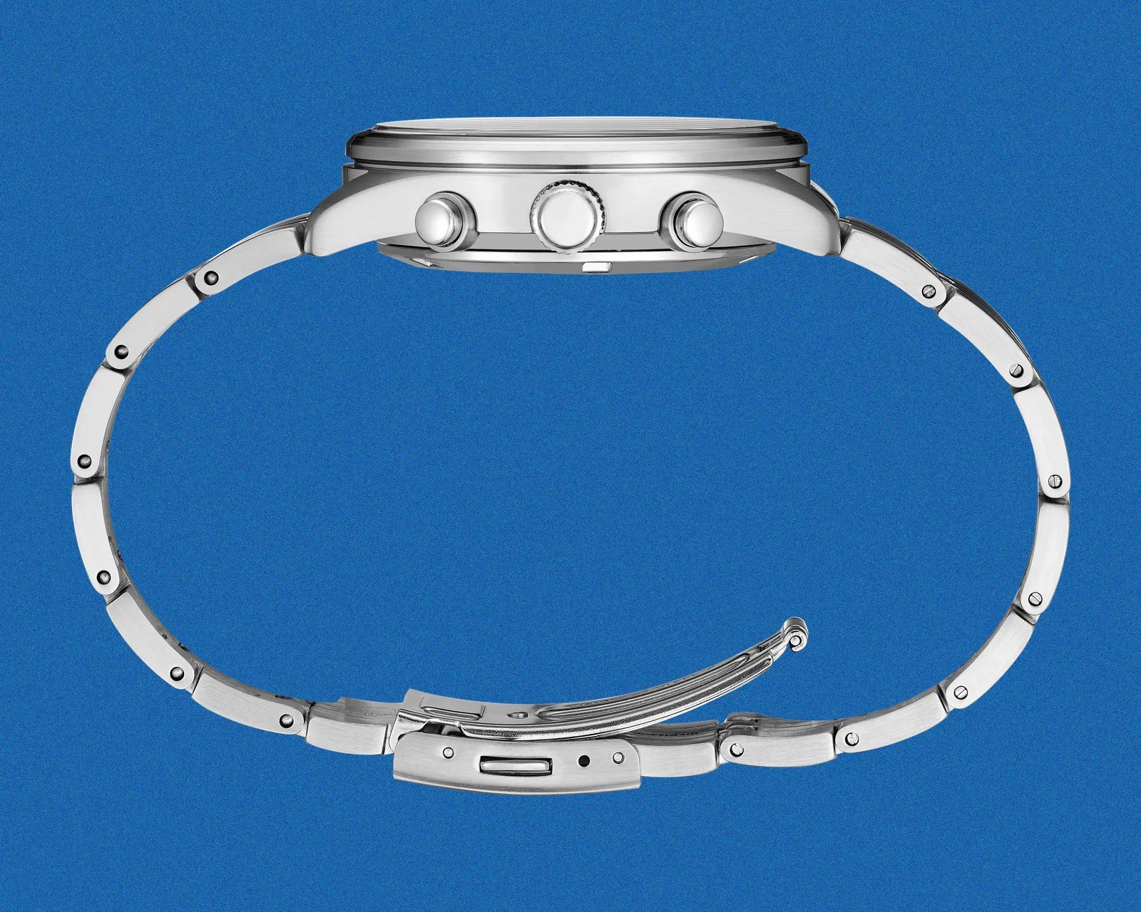 Side view of a silver metal wristwatch with a linked bracelet and three buttons on the case against a blue background.