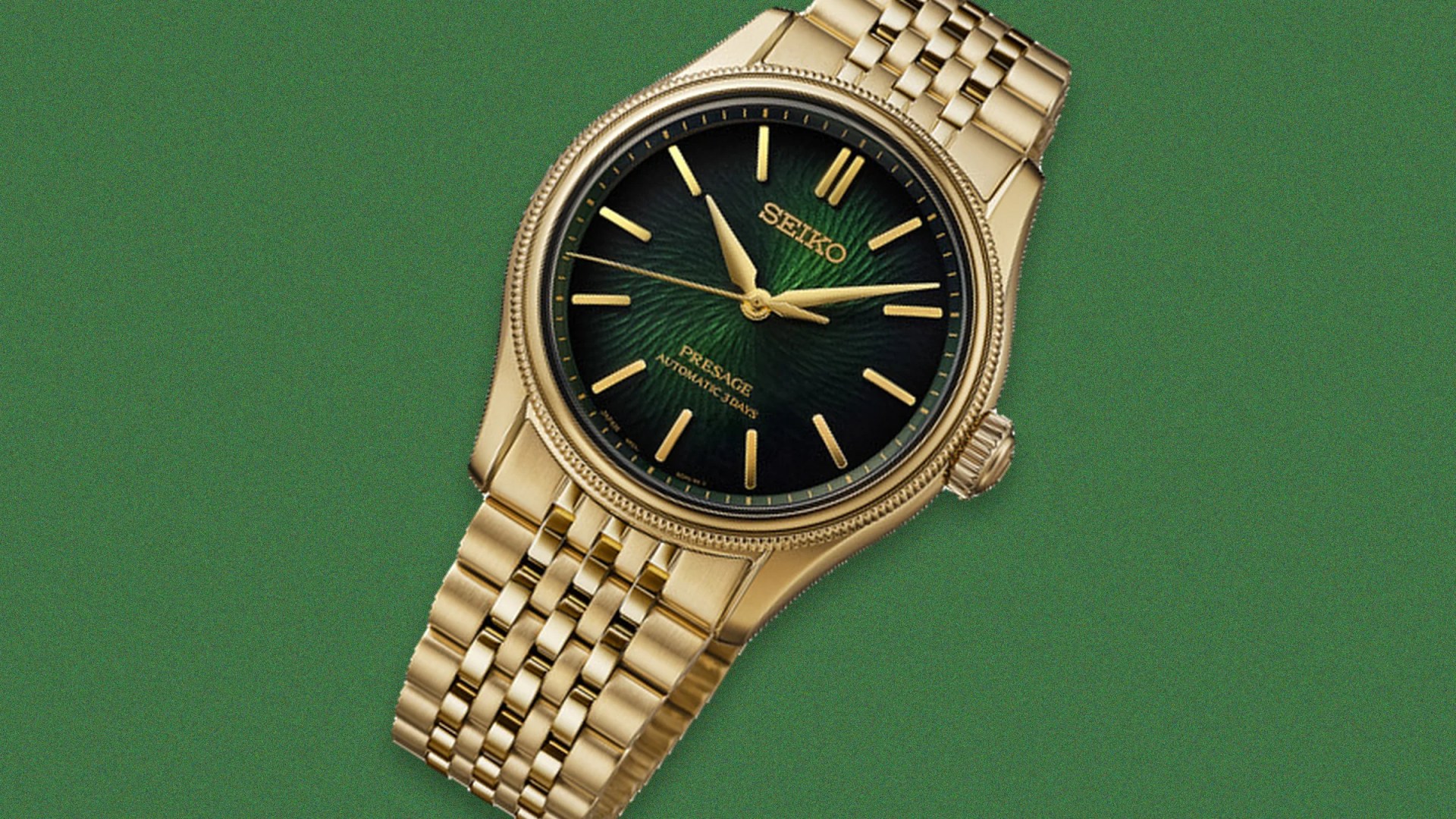 Gold Seiko Presage automatic wristwatch with a textured green dial and gold bracelet on a green background.