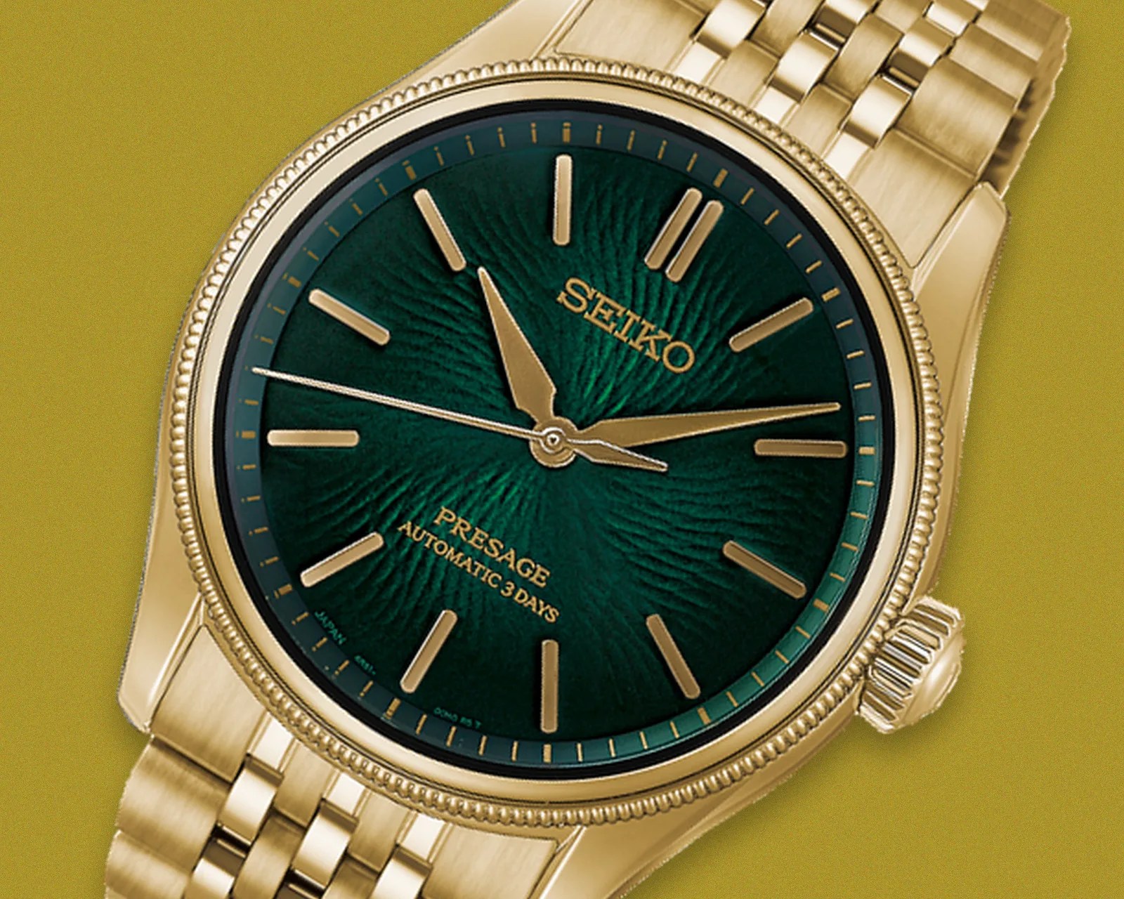 Gold Seiko Presage watch with textured green dial and gold hour markers on a gold metal bracelet.