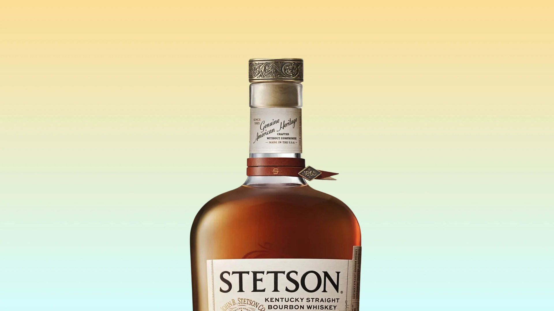 Top portion of a Stetson Kentucky Straight Bourbon Whiskey bottle with a decorative metal cap and leather strap tag.