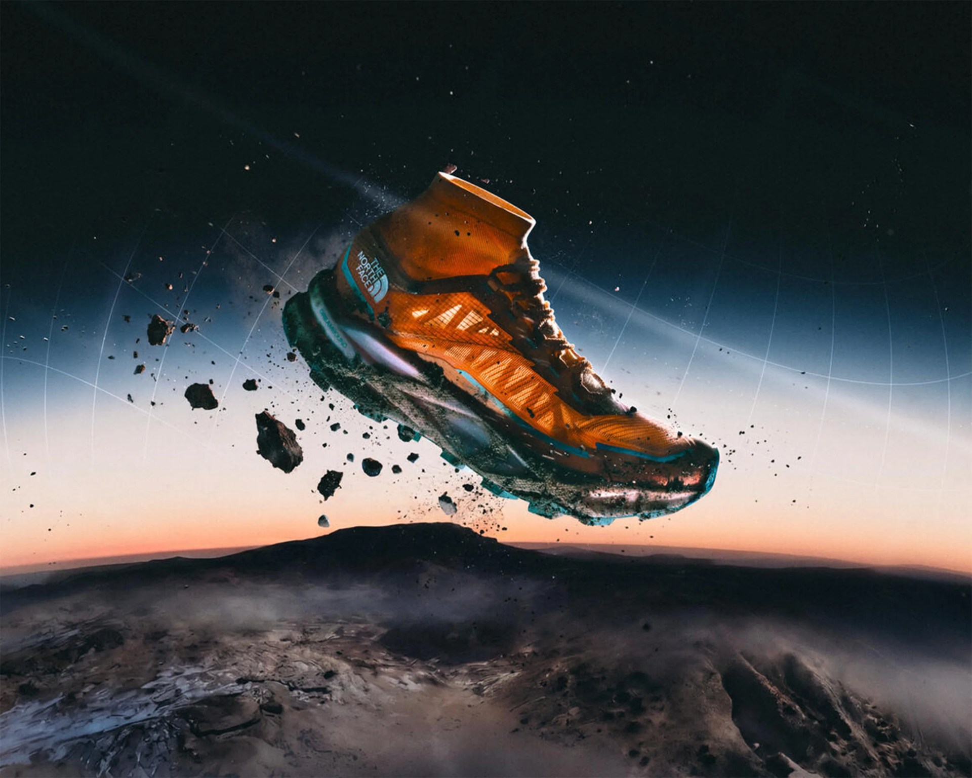 Orange The North Face trail running shoe with mud and dirt floating above a rocky landscape at dusk.