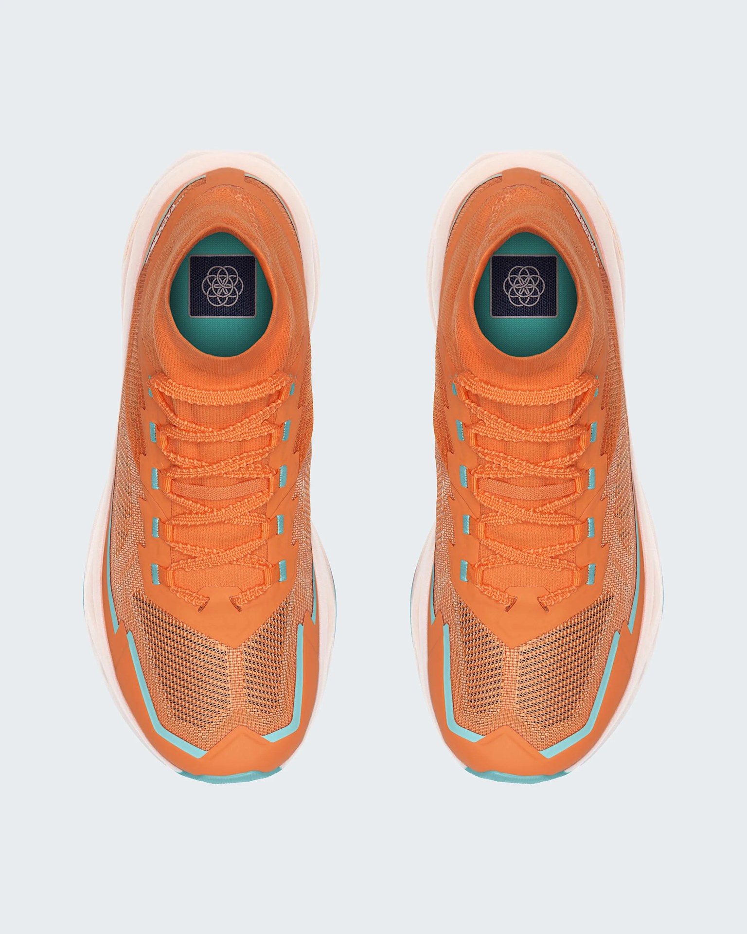 Pair of orange athletic shoes with turquoise accents and white soles viewed from above.