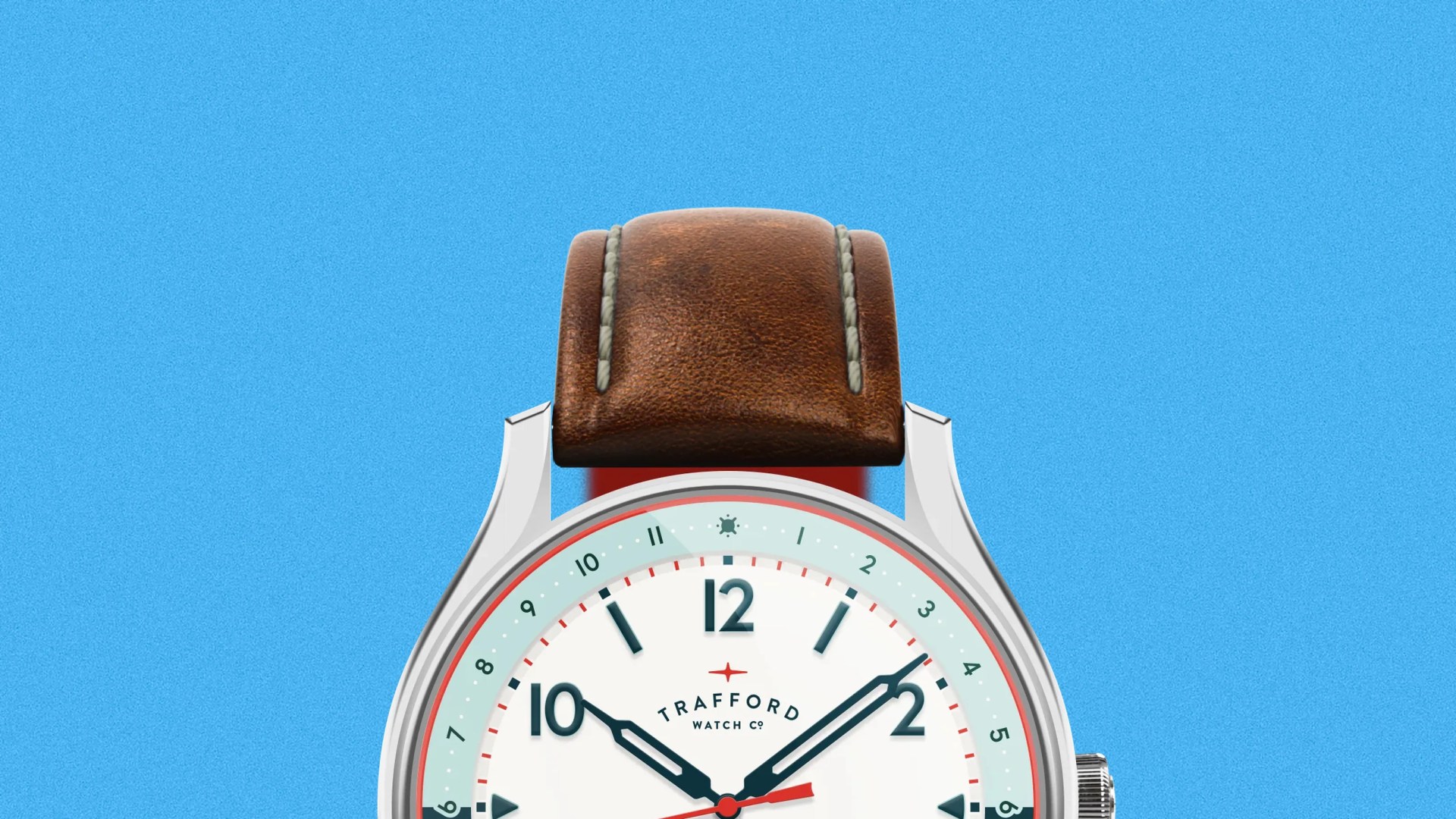 Close-up of a wristwatch with a brown leather strap and a white dial showing the brand "Trafford Watch Co." against a blue background.