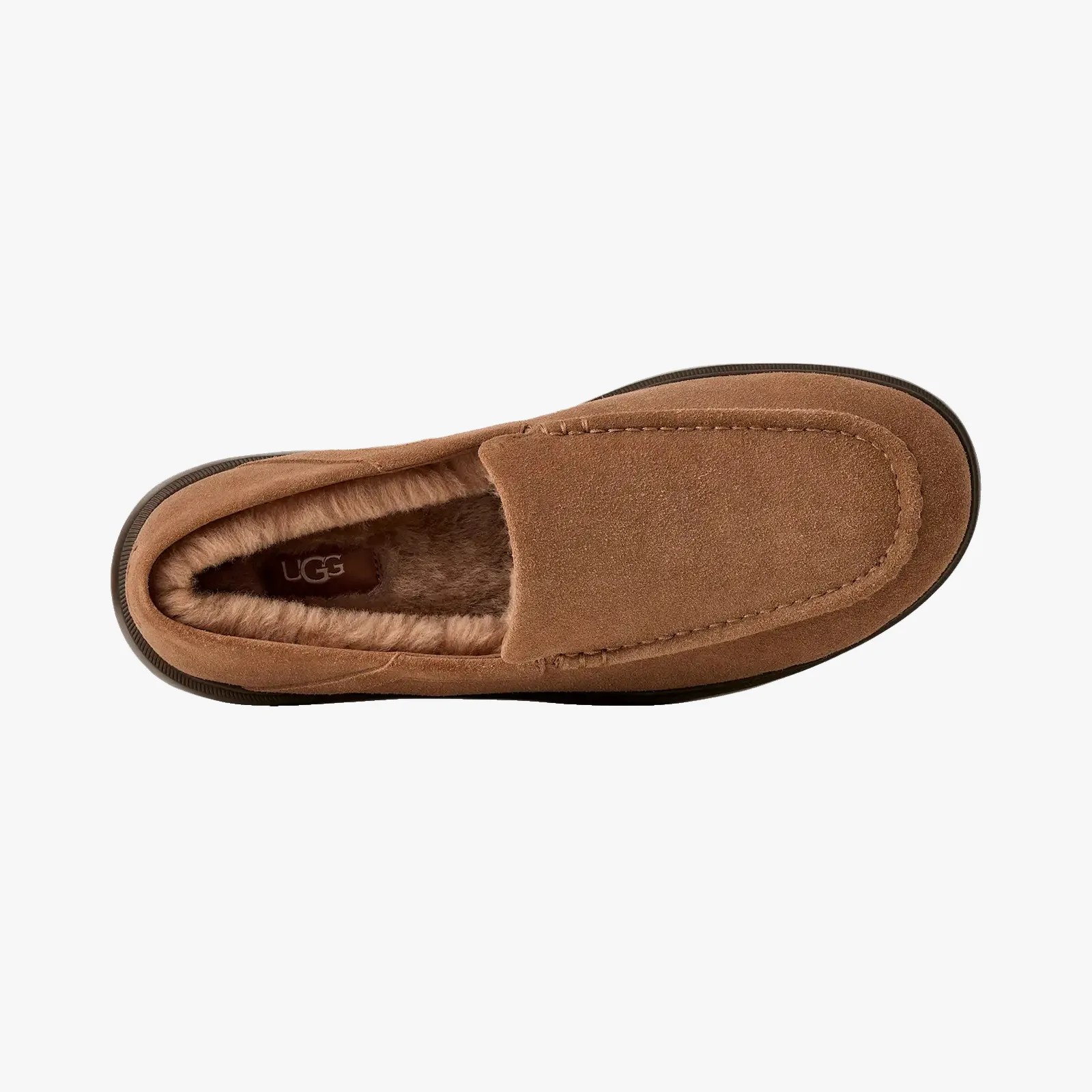 Brown suede UGG slipper with plush fur lining and black sole, viewed from above.