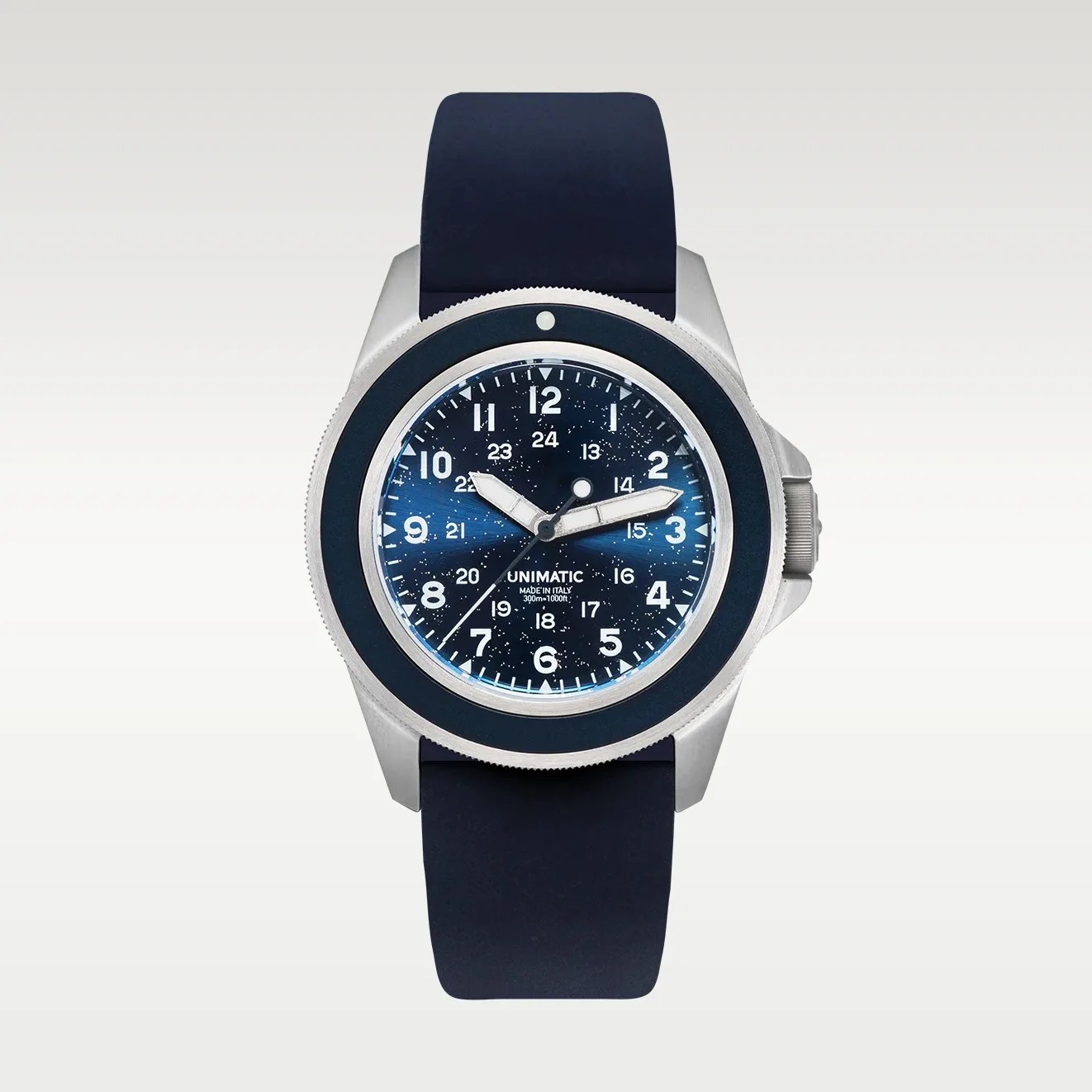 Stainless steel Unimatic watch with a blue speckled dial, white numerals, and a dark blue rubber strap.