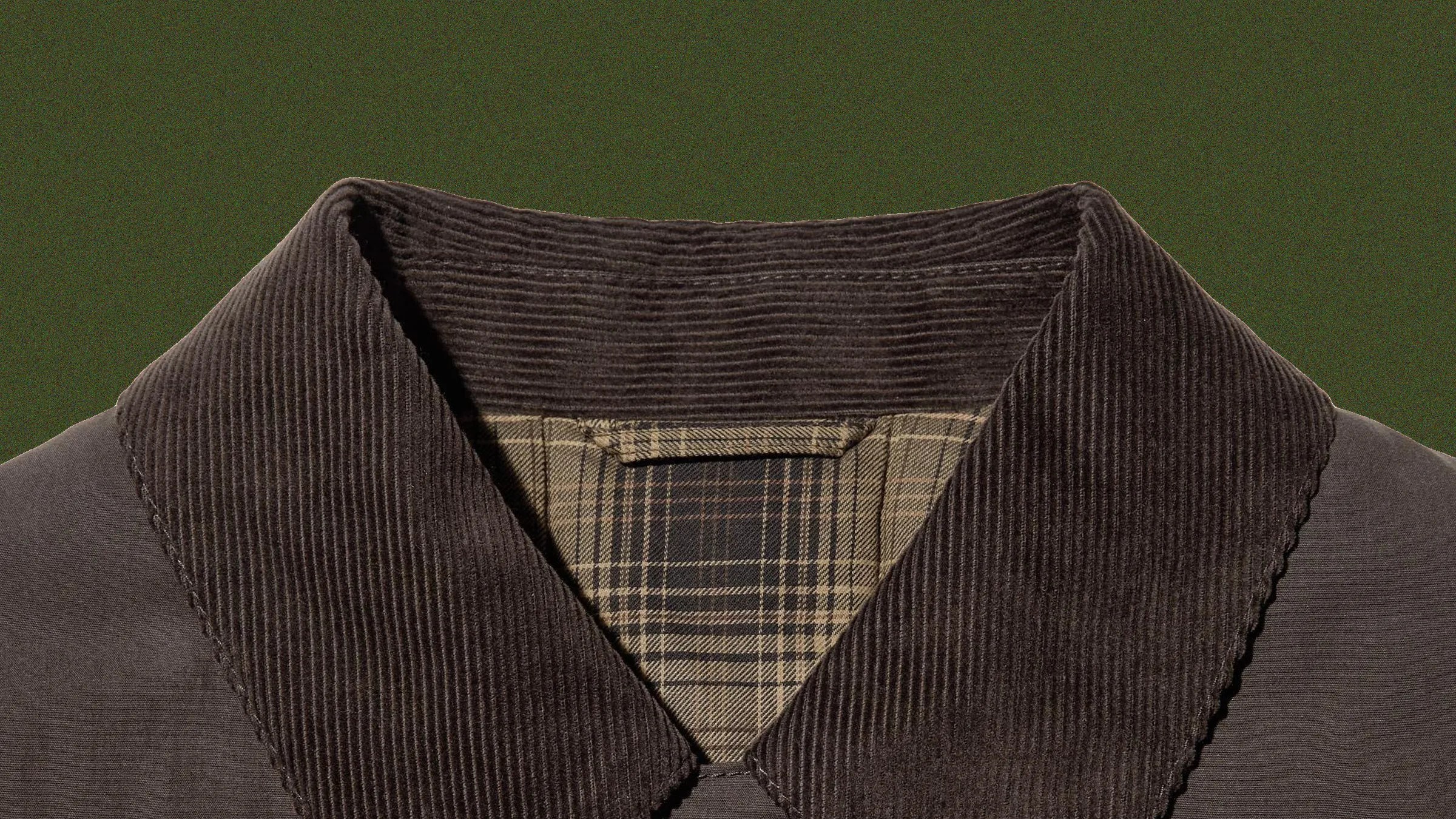 Dark brown corduroy jacket collar with beige and brown plaid lining visible inside.