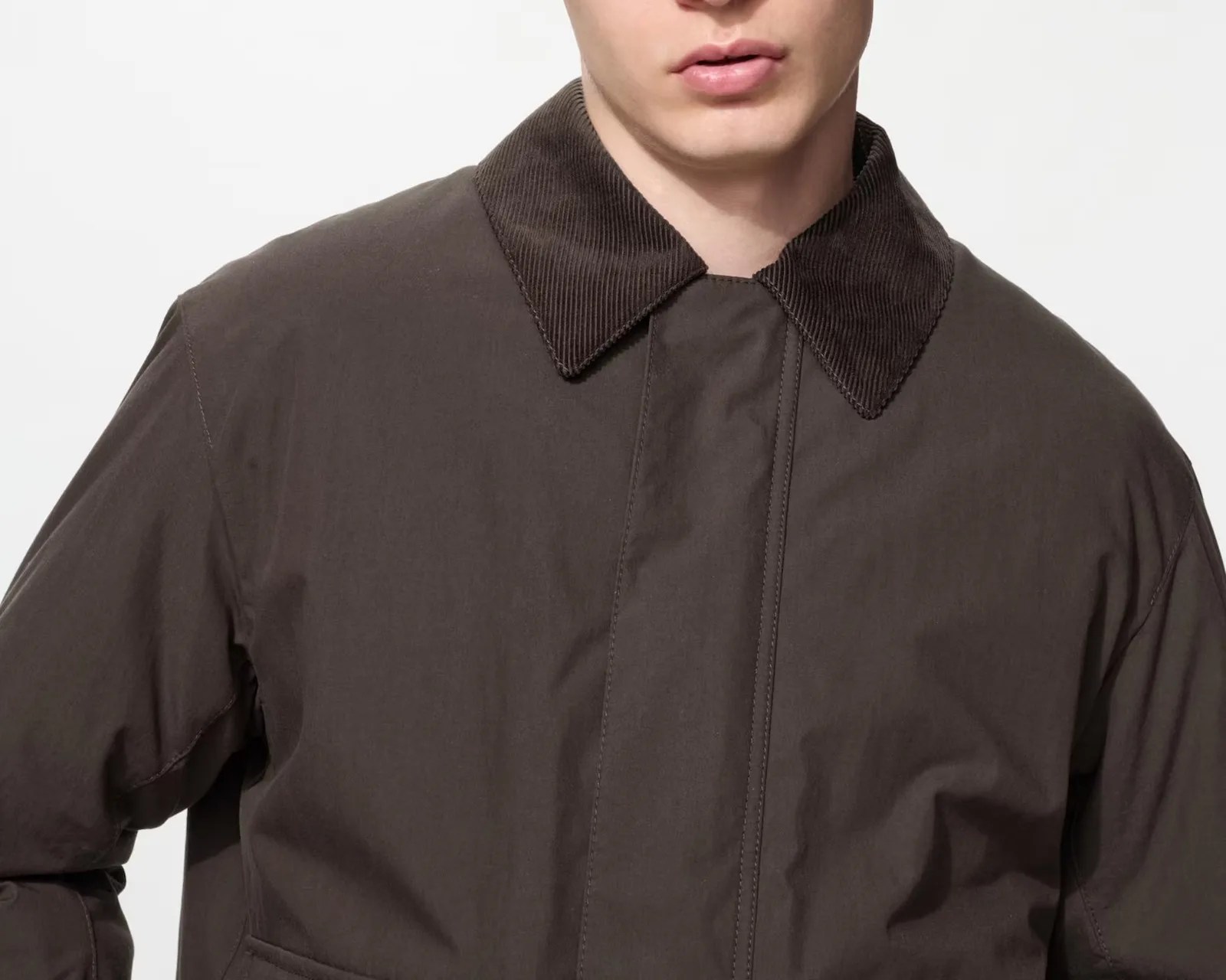 Dark brown jacket with a corduroy collar worn by a person, shown from the shoulders to mid-chest.