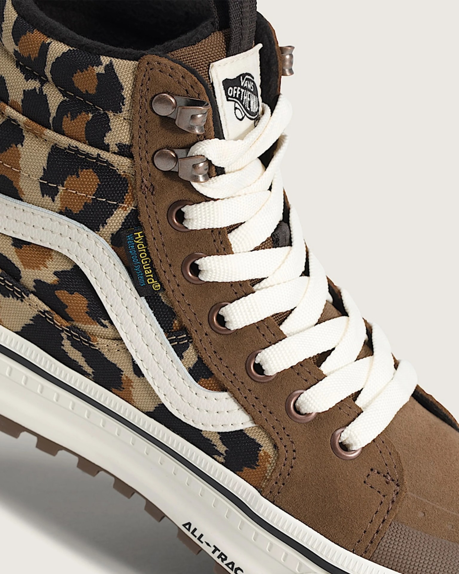 Brown and leopard print Vans high-top sneaker with white laces and white side stripe.