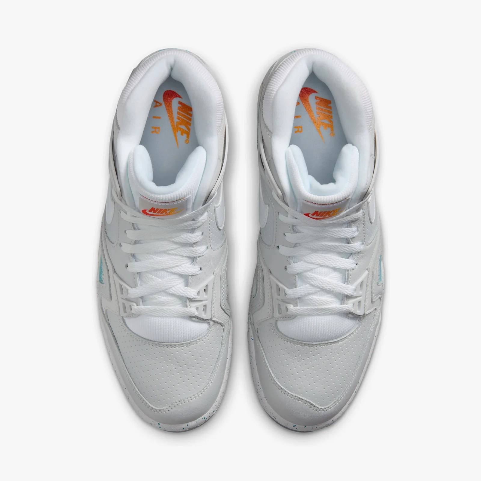 Top view of white Nike Air sneakers with orange Nike logo on the insoles and tongues.