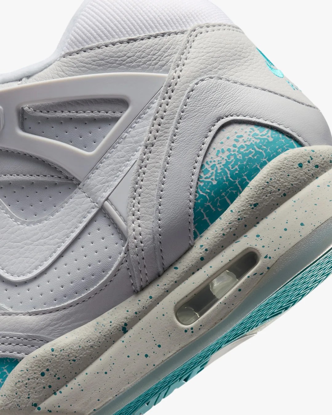 Close-up of a white leather sneaker heel with teal cracked paint detail and speckled midsole.
