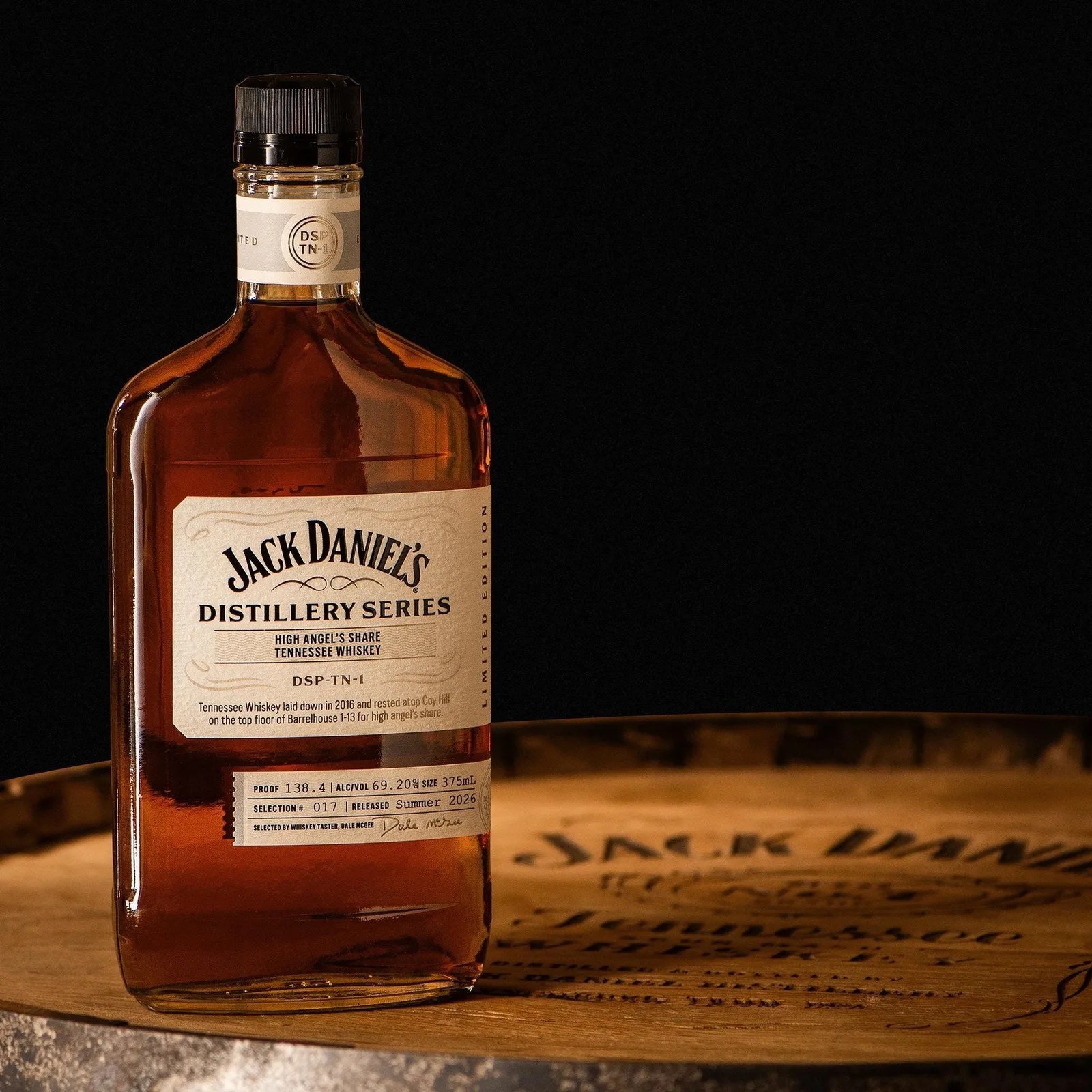 Jack Daniel's Distillery Series High Angel's Share Tennessee Whiskey bottle on a wooden barrel.