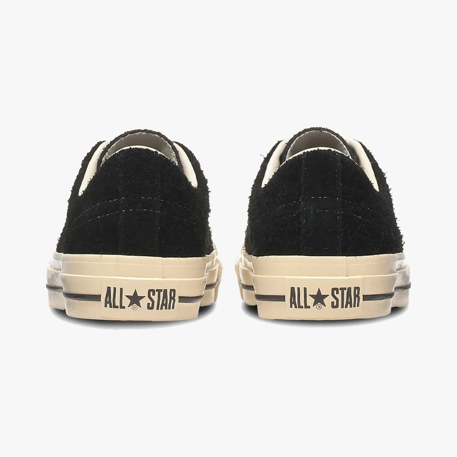 Pair of black fuzzy-textured Converse All Star sneakers shown from the back with off-white soles and "ALL STAR" text.